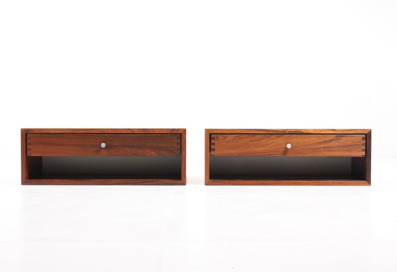 Pair of floating wall nightstands in rosewood with steel hardware. Designed by Danish Kai Kristiansen and made by cabinetmaker Aksel Kjersgaard. Great original condition.

  