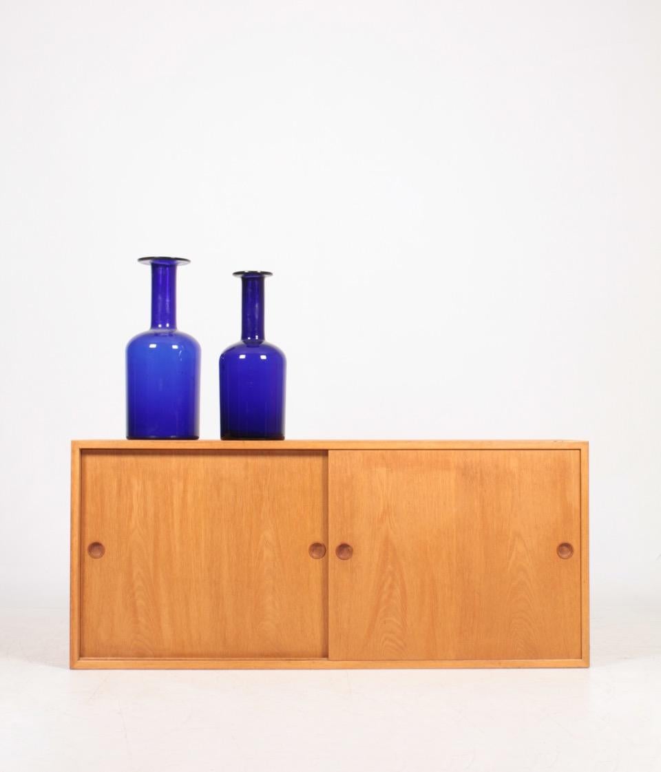 Wall-mounted cabinet in oak. Designed by Børge Mogensen for Karl Andersson, Sweden. Great condition.
 
