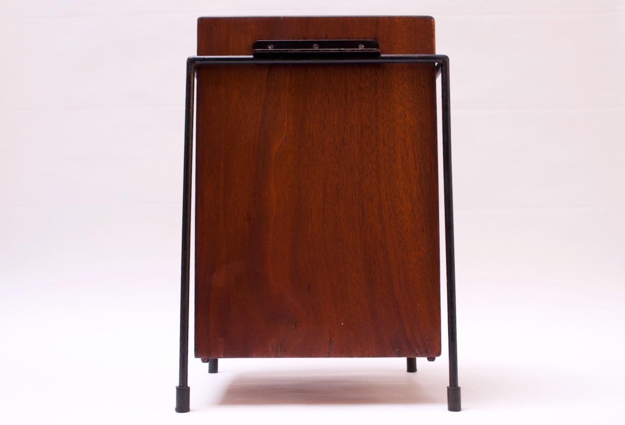 Uncommon circa 1950s walnut and iron wastebasket designed and custom-produced by Alvin Lustig for the executive offices of JL Hudson (Southfield, MI).
Features a walnut box / basket supported by a painted iron frame retaining the original feet.