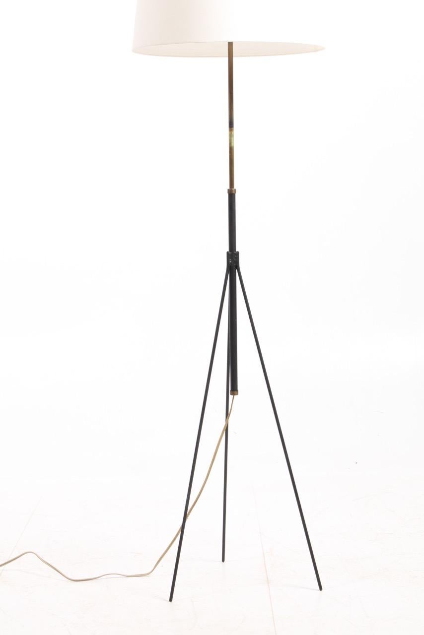 Great looking floor lamp with adjustable height in black painted metal and brass. Designed and made by S. A. Holm Sørensen in the mid-1950s. Great original condition.