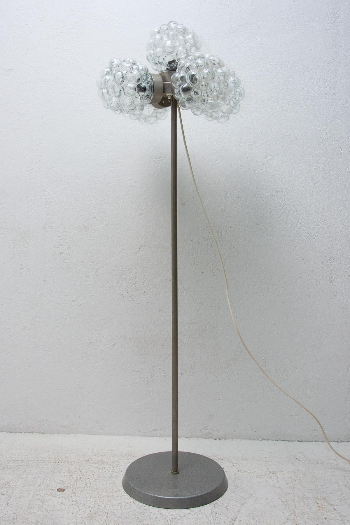 Mid century vintage metal floor lamp, it was made by Kamenický Šenov company in the former Czechoslovakia in the 1970´s. The lamp features the slender leg, metal construction and three glass shades. This lamp is fitted with three E27 bulbs and has