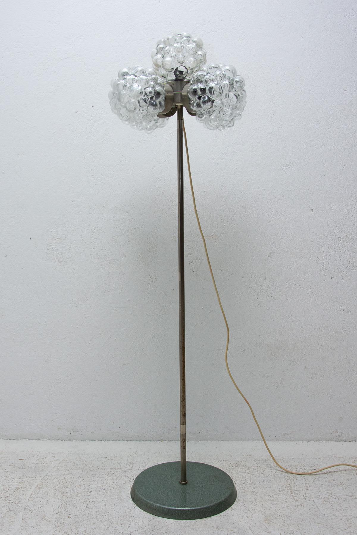 Mid-century Vintage metal floor lamp, it was made by Kamenický Šenov company in the former Czechoslovakia in the 1970´s. The lamp features the slender leg, metal construction and three glass shades. This lamp is fitted with three E27 bulbs and has