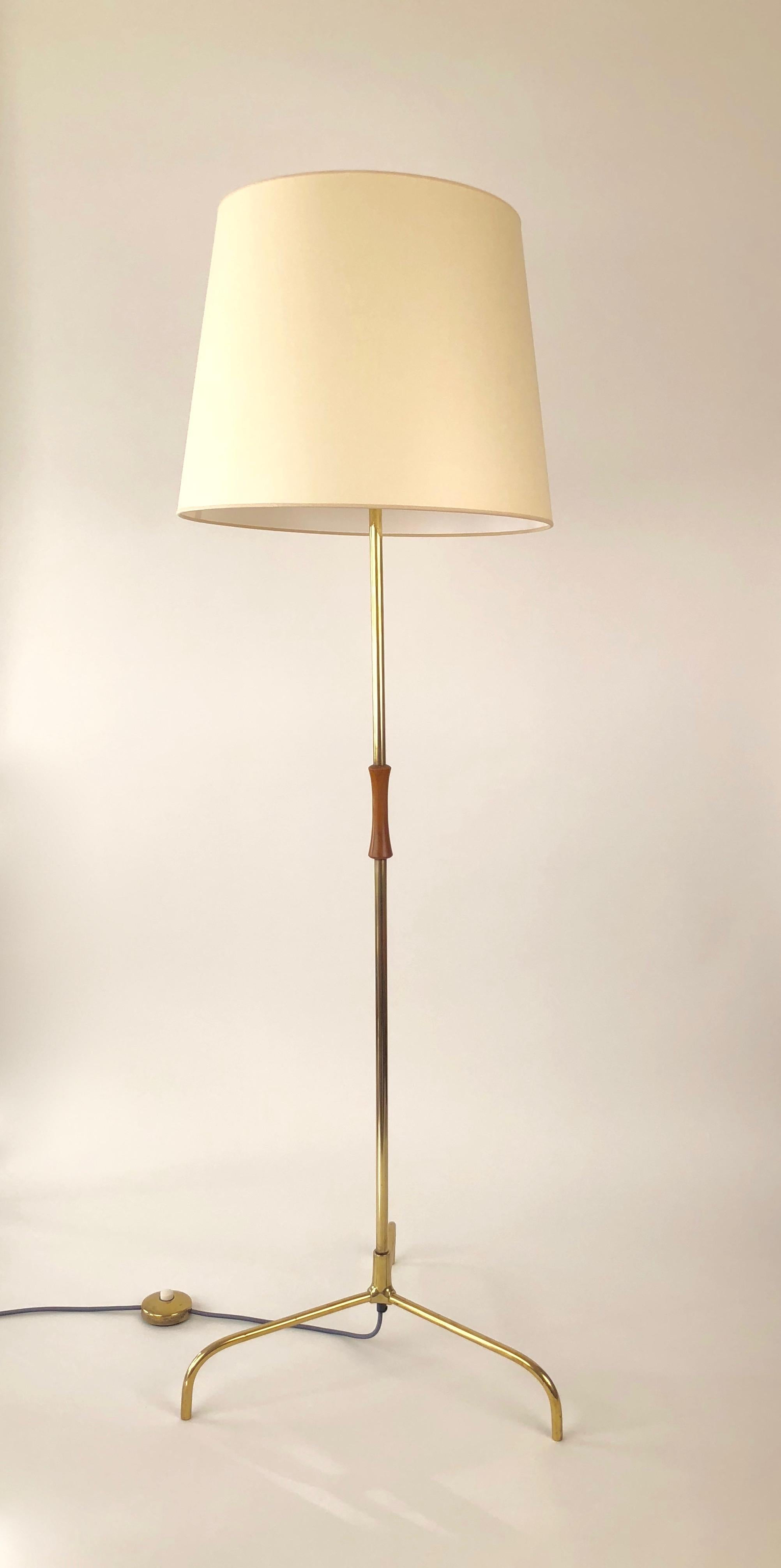 An elegant midcentury floor lamp from Kalmar, Manufactured in the 1950s in Vienna Austria, this polished brass floor lamp has been rewired with a grey cloth covered cable. The shade is new and represents the same proportions as the original. The