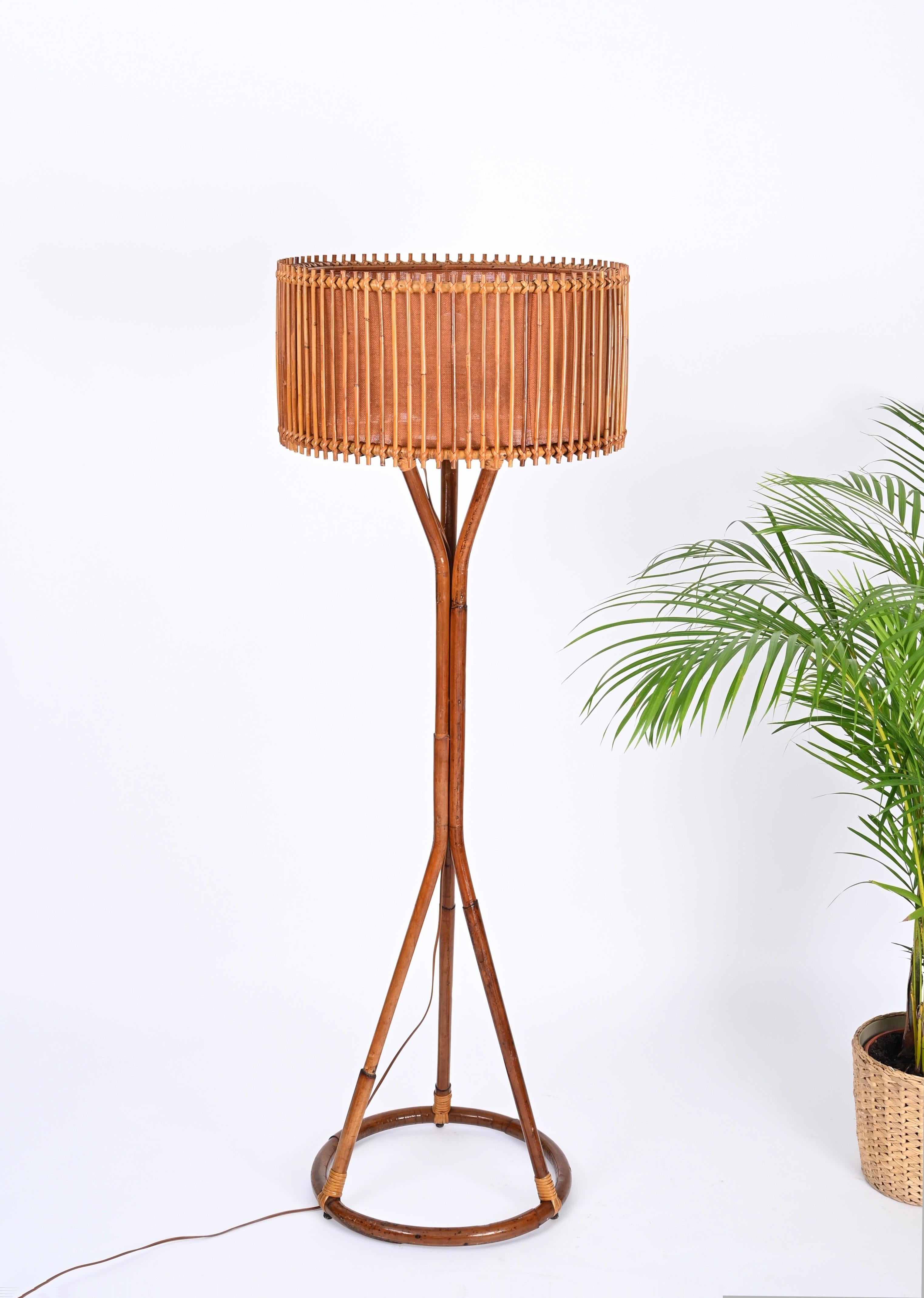 Fantastic Mid-Century floor lamp fully made in curved bamboo and hand-woven rattan wicker. This rare lamp was designed In Italy during the 1960s and is attributed to the mastery of Franco Albini. 

This stylish floor lamp features a round base that
