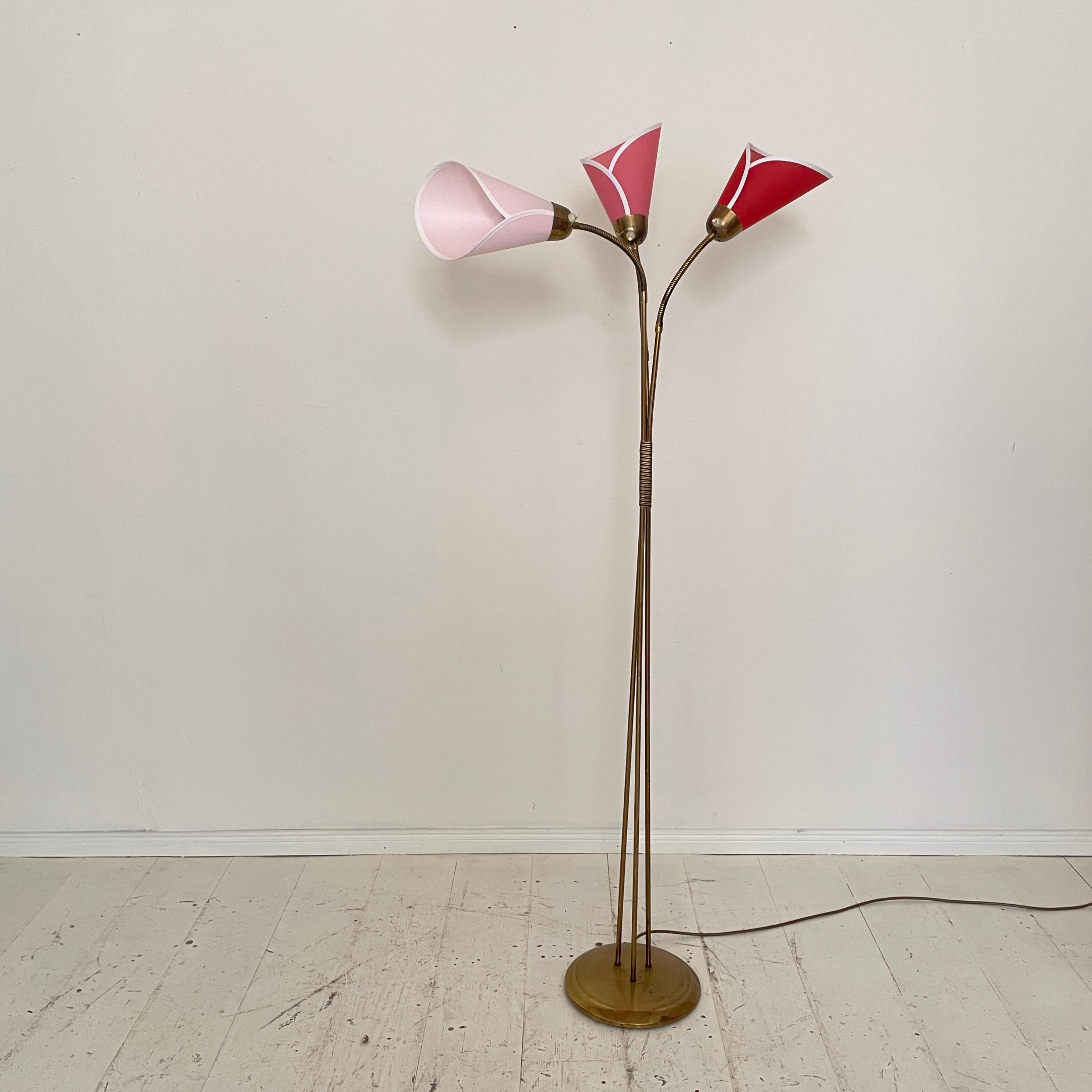 This elegant Mid-Century Floor Lamp in Brass was designed and made around 1952 in Germany.
The lamp has got three movable arms which you can move in any direction. Also each arm has its own light switch. The re-done fabric shades come in three