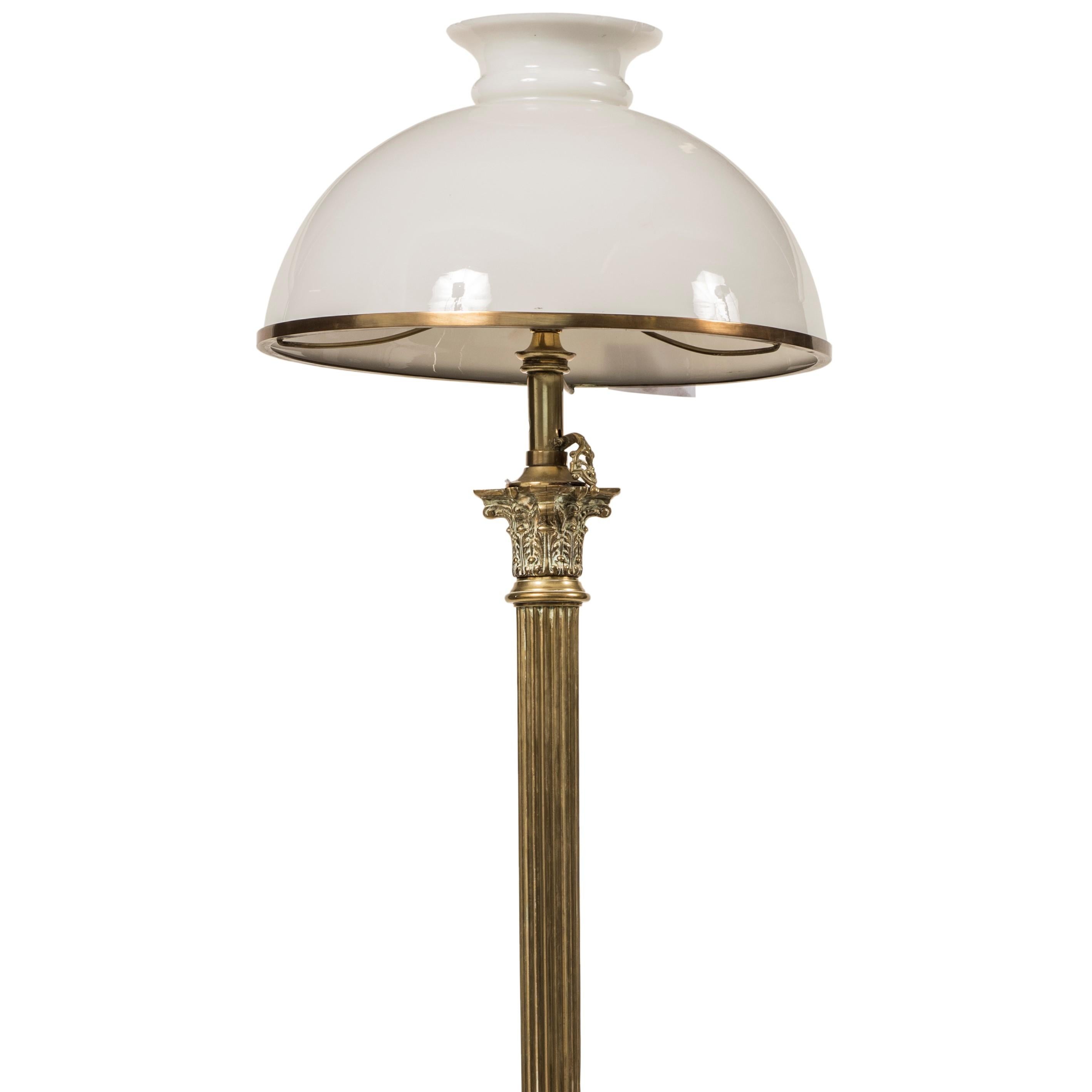 This vintage floor lamp was designed by an Italian Manufacturer and realized in Italy in the 1950s.

The lamp has a bronze stem ending in Corinthian capital and a quadrangular base decorated with floral motifs. Hemispherical opal glass ceiling