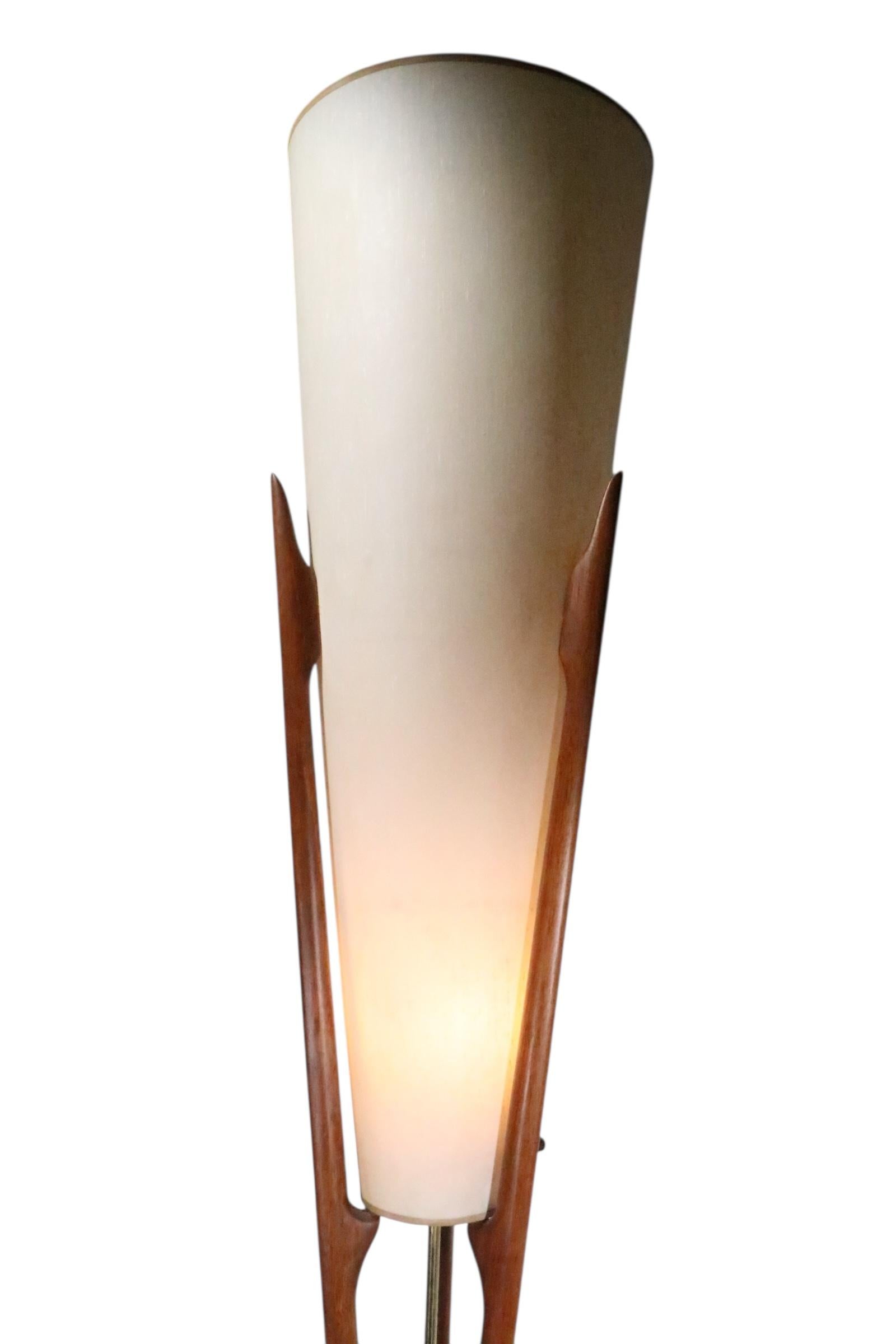 Rare Mid Century floor lamp torchiere, model 1525 designed by Arnold Jacobs for Modeline, circa 1950/60's. The lamp features a conical shade within the sculptural walnut base.  The lamp has two interior sockets each accepts a standard size screw in