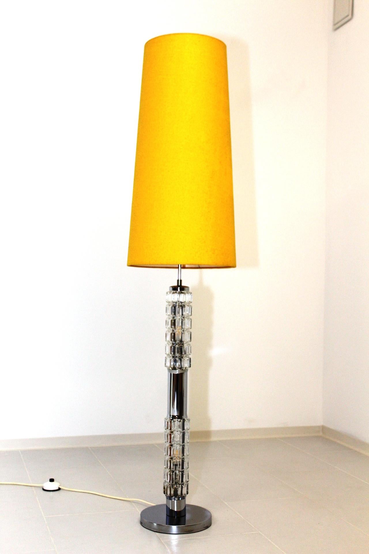 Chrome and glass floor lamp with 2 bulbs in the stand and one bulb under the shade. This piece has a manufacturer’s label.