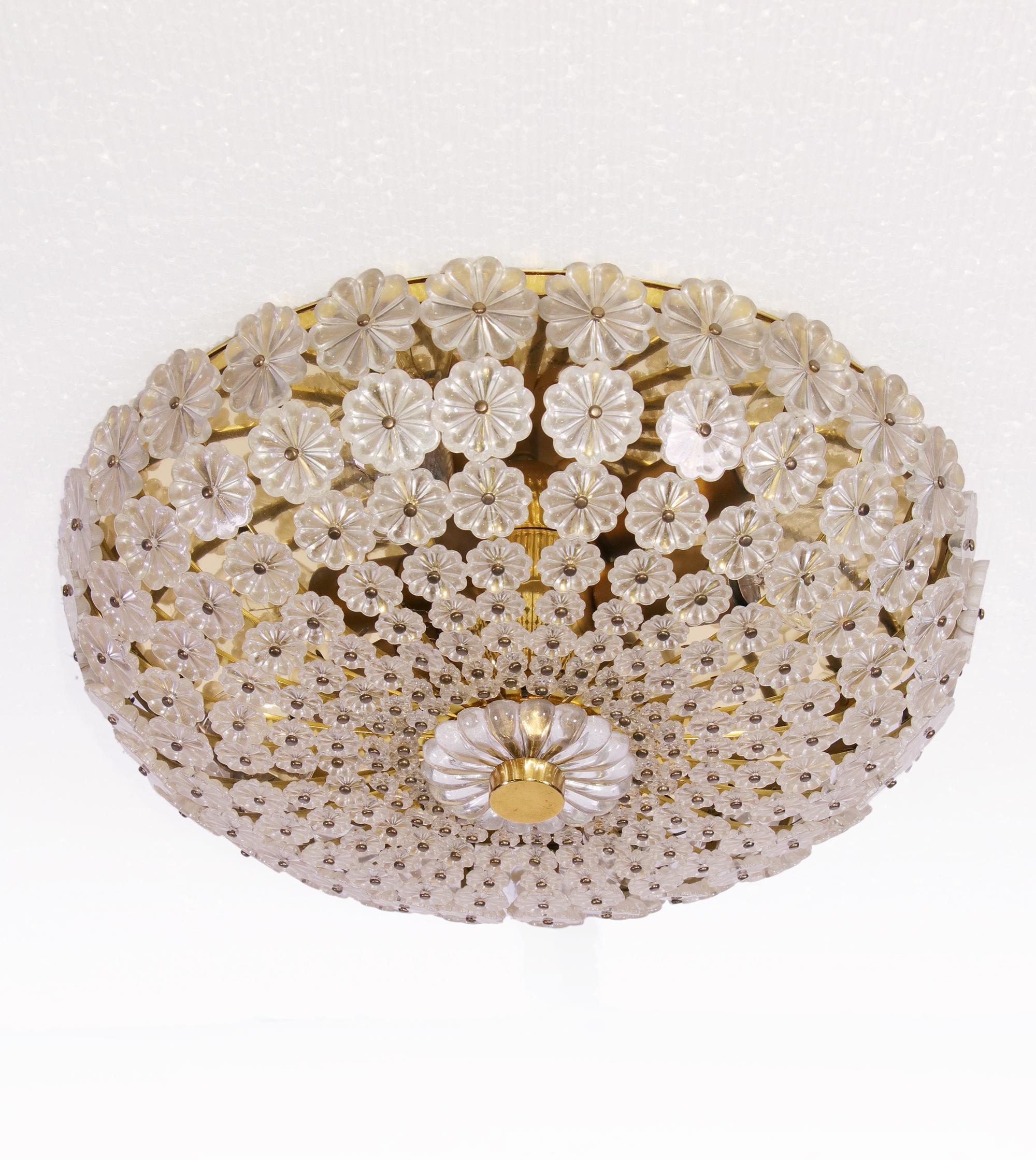 Elegant mid century flush mount ceiling light with small glass flowers on a brass frame. Manufactured by H. Richter, Germany in the 1950s. 

Design: H. Richter. 
Measures: diameter 12.4