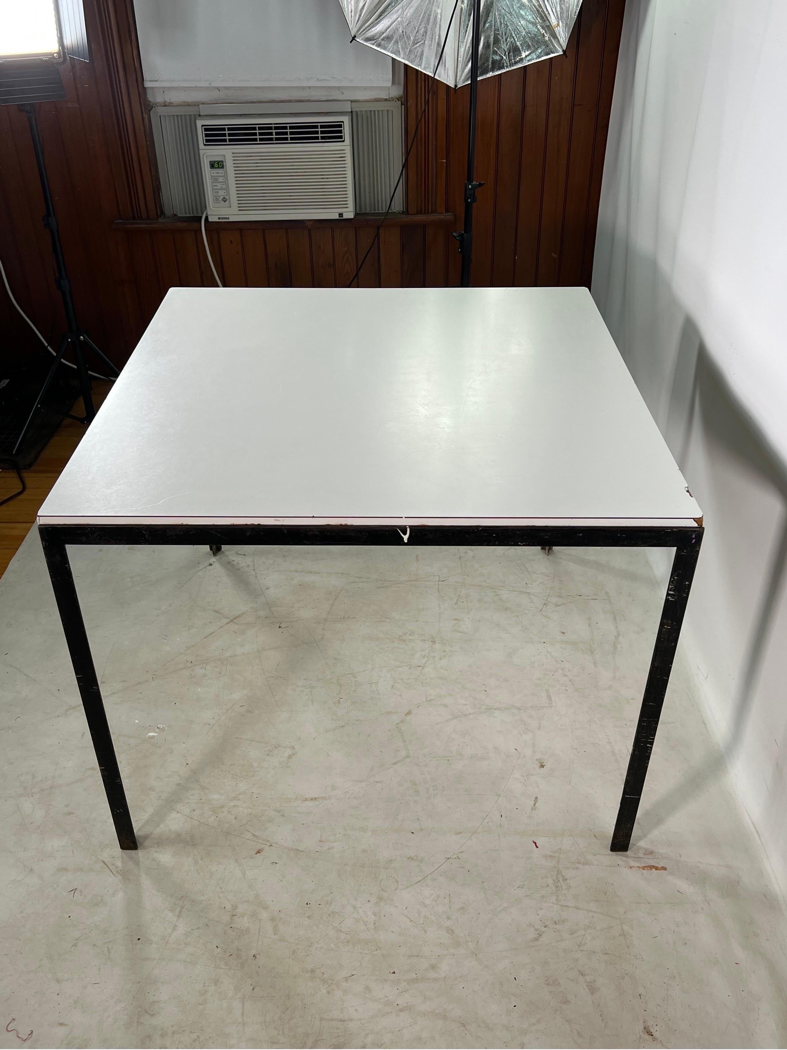 Mid Century Florence Knoll Iron T bar kitchen table. The table is made out of CastIron and has a white Laminate top.