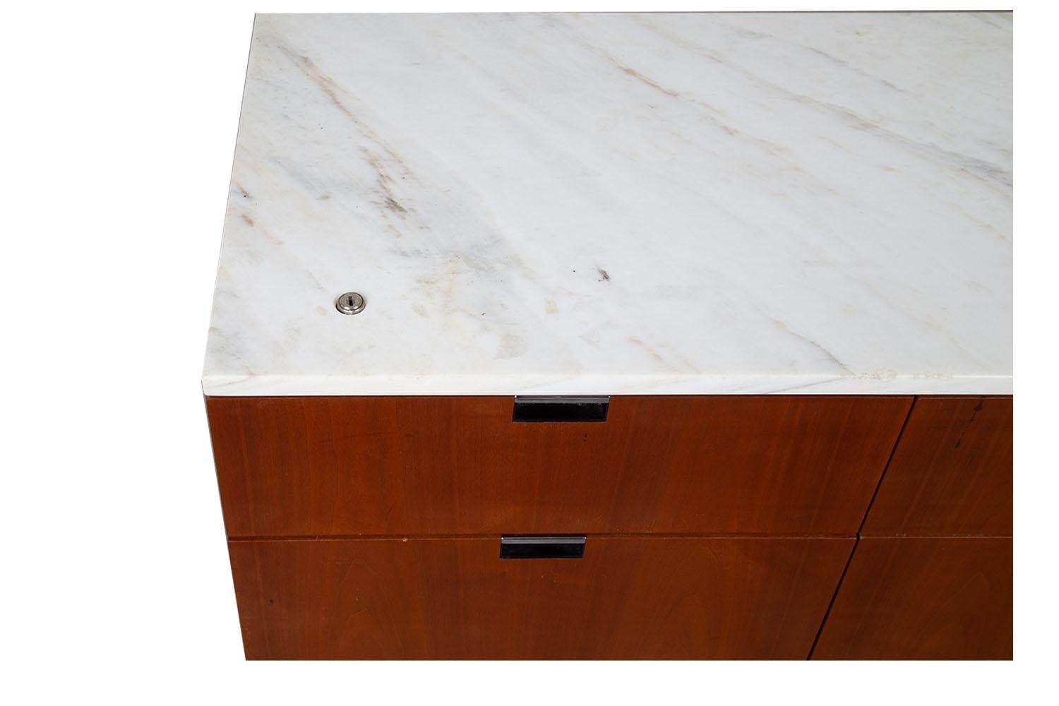 Remarkably iconic Mid-Century, marble top, four drawer file cabinet by Florence Knoll, for Knoll inc., ca. 1980s. A beautiful example of Mid-Century craftsmanship. Expertly crafted, Featuring richly grained walnut frame, with a fully finished back