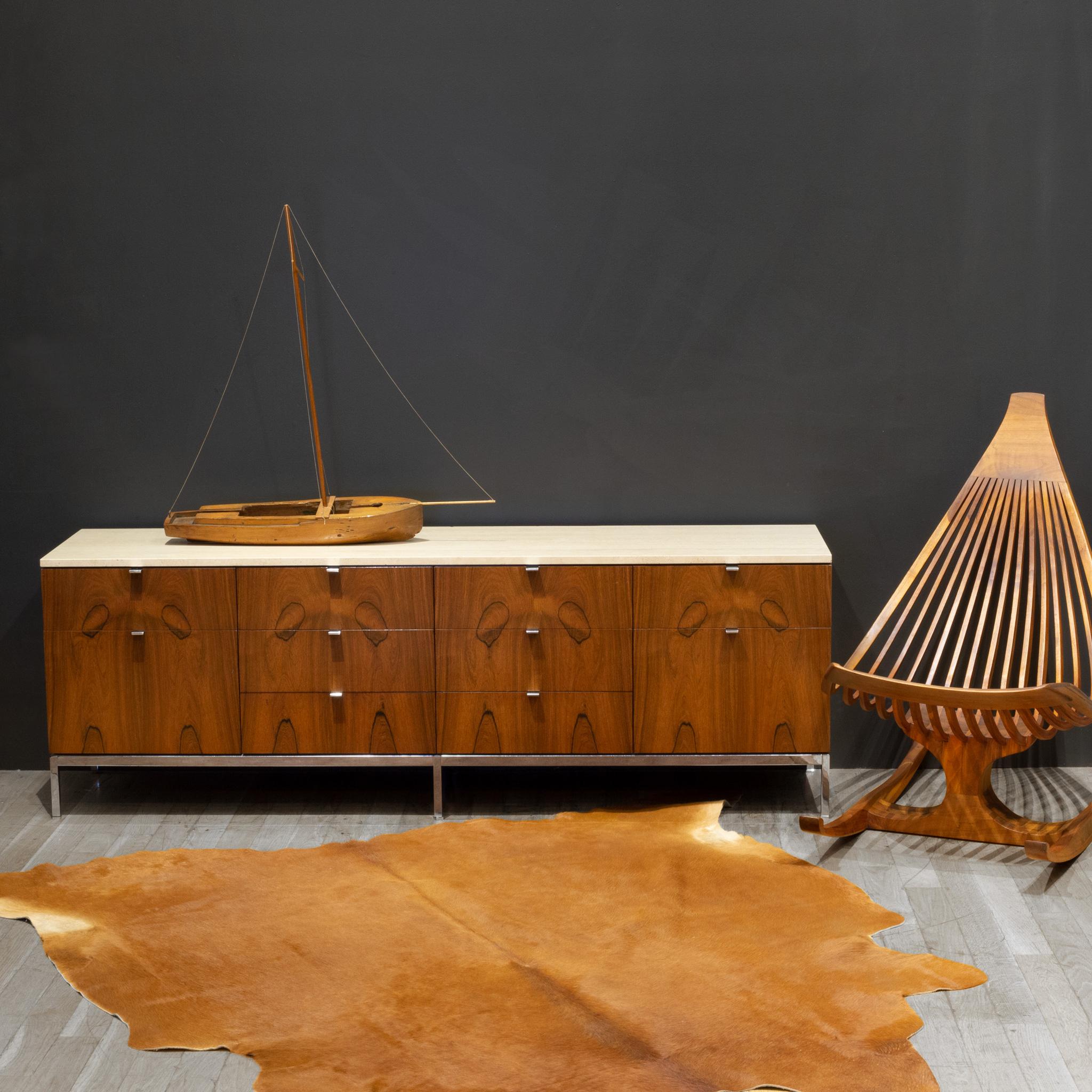 ABOUT

Florence Knoll's modernist credenza for Knoll features a gorgeous rosewood case sitting on slender chrome legs and topped with a Travertine slab. Inset chrome handles open ten drawers: two file drawers at either end and eight shallower