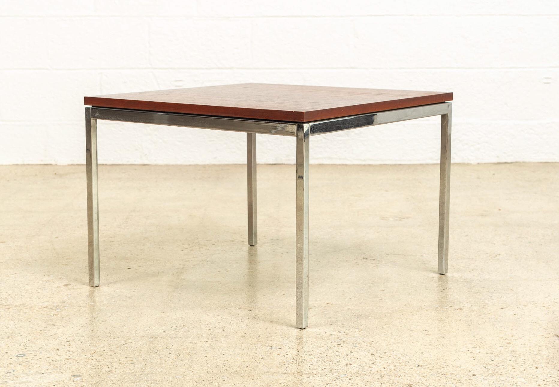 This vintage Mid-Century Modern Florence Knoll for Knoll Associates, Inc. square wood coffee table is circa 1960 and features a walnut wood top on a steel frame. This iconic table is a mid century modern classic and exemplifies the clean, minimalist