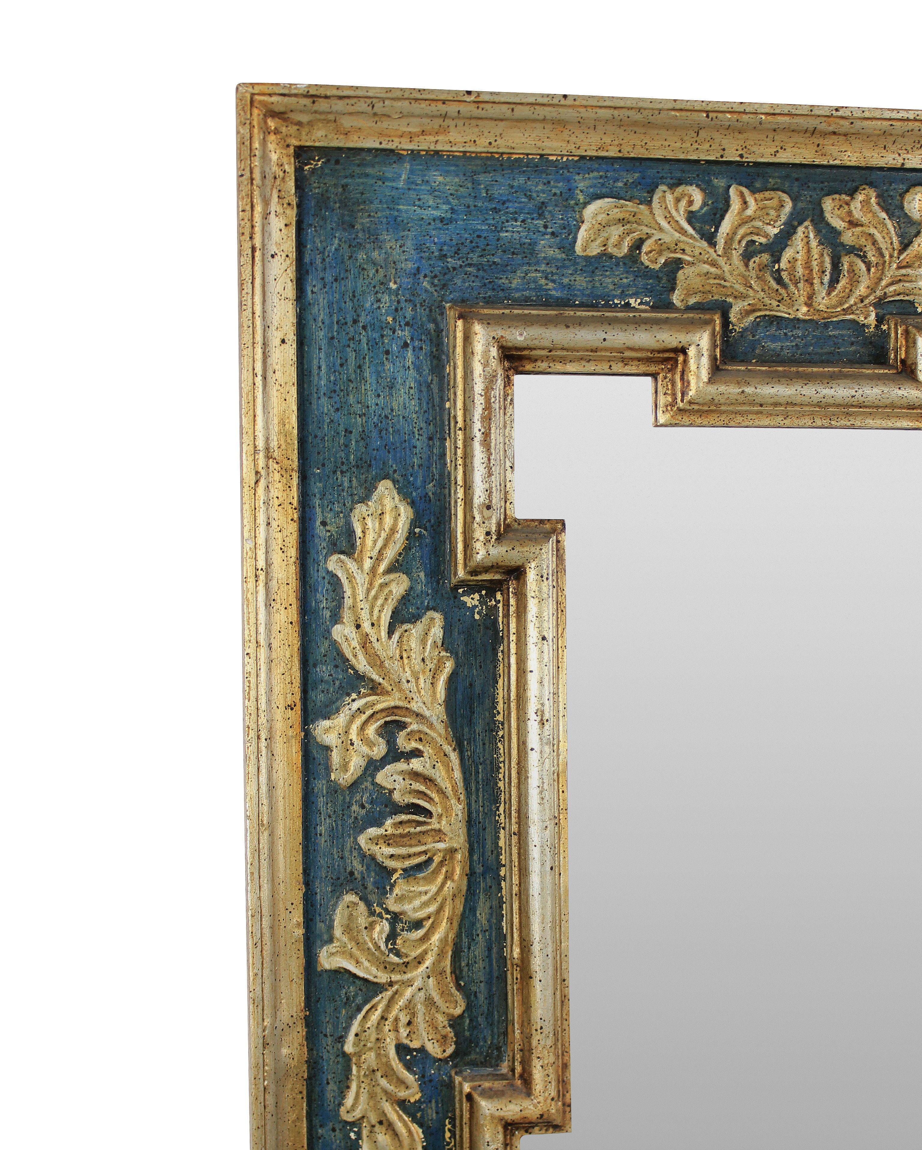 A mid-century florentine mirror in a green painted finish with gold and silver leaf, in the 18th century style.