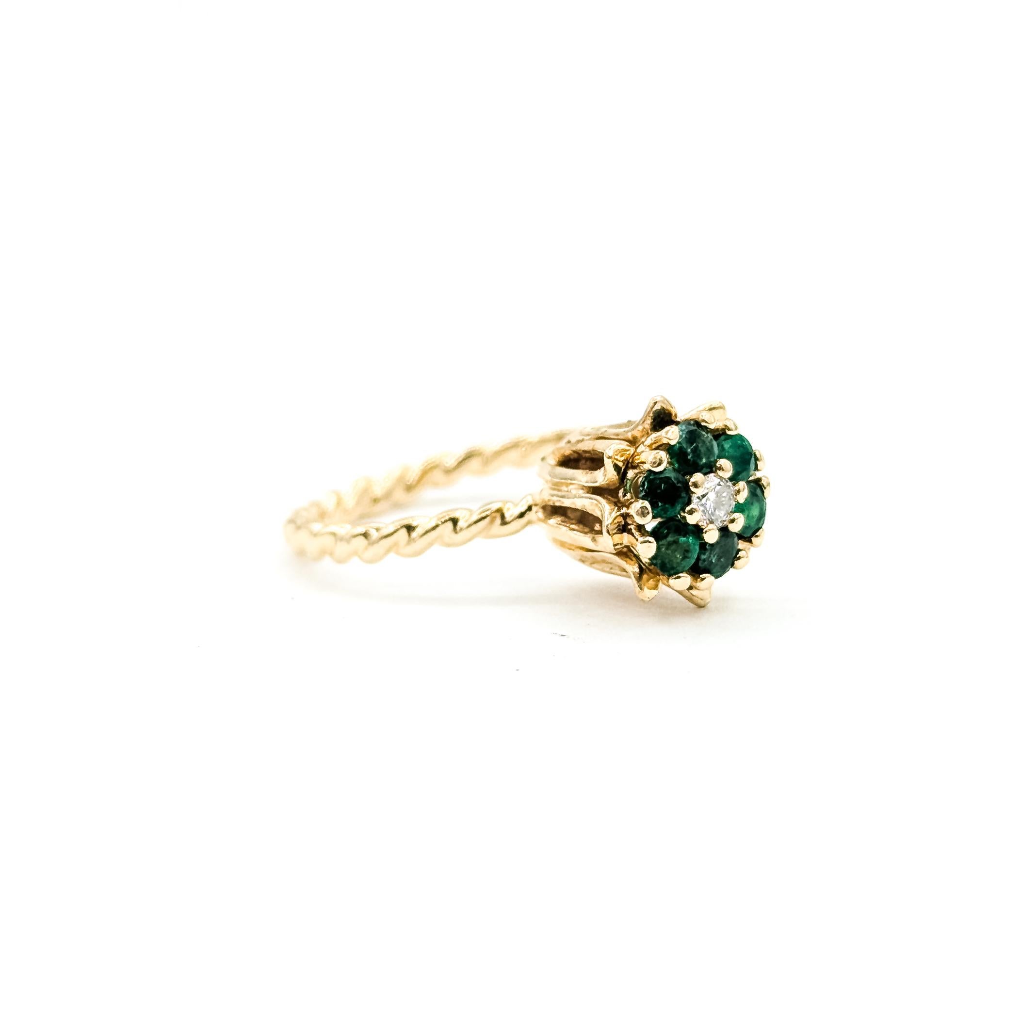 Mid-Century Flower Emerald 
Diamond Ring in 14k Yellow Gold

This charming Mid-Century flower ring is crafted in 14k yellow gold and set with bright green prong-set emeralds totaling 0.50ctw, arranged in a classic floral cluster. A round
