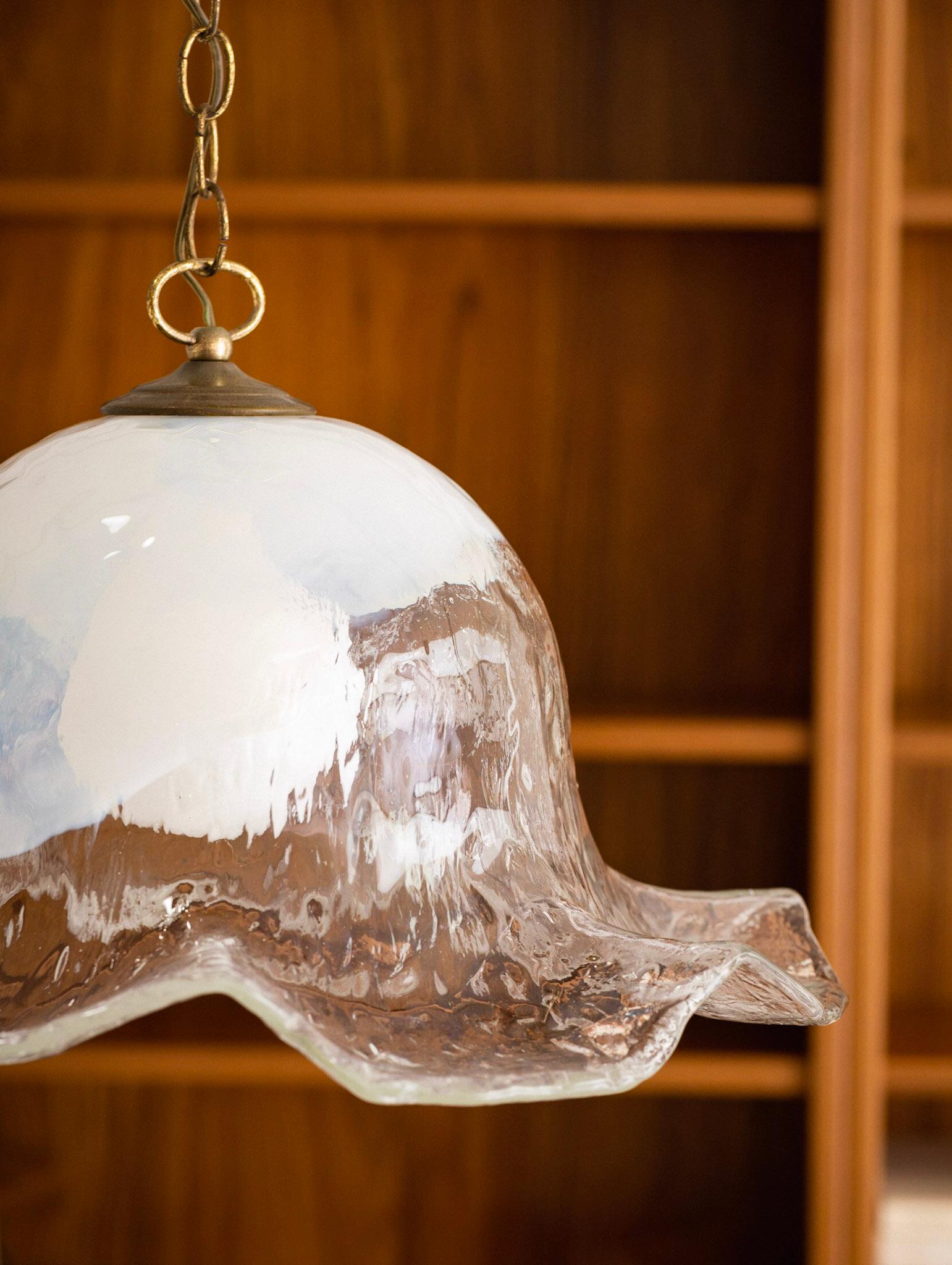 Sculptural hand-blown Murano glass pendant lamp, attributed to Mazzega Murano. Asymmetrical white coloring in the glass. Hardwire, can be rewired at your own discretion. Comes with brass ceiling canopy and brass chain, Measures: approximately 12”