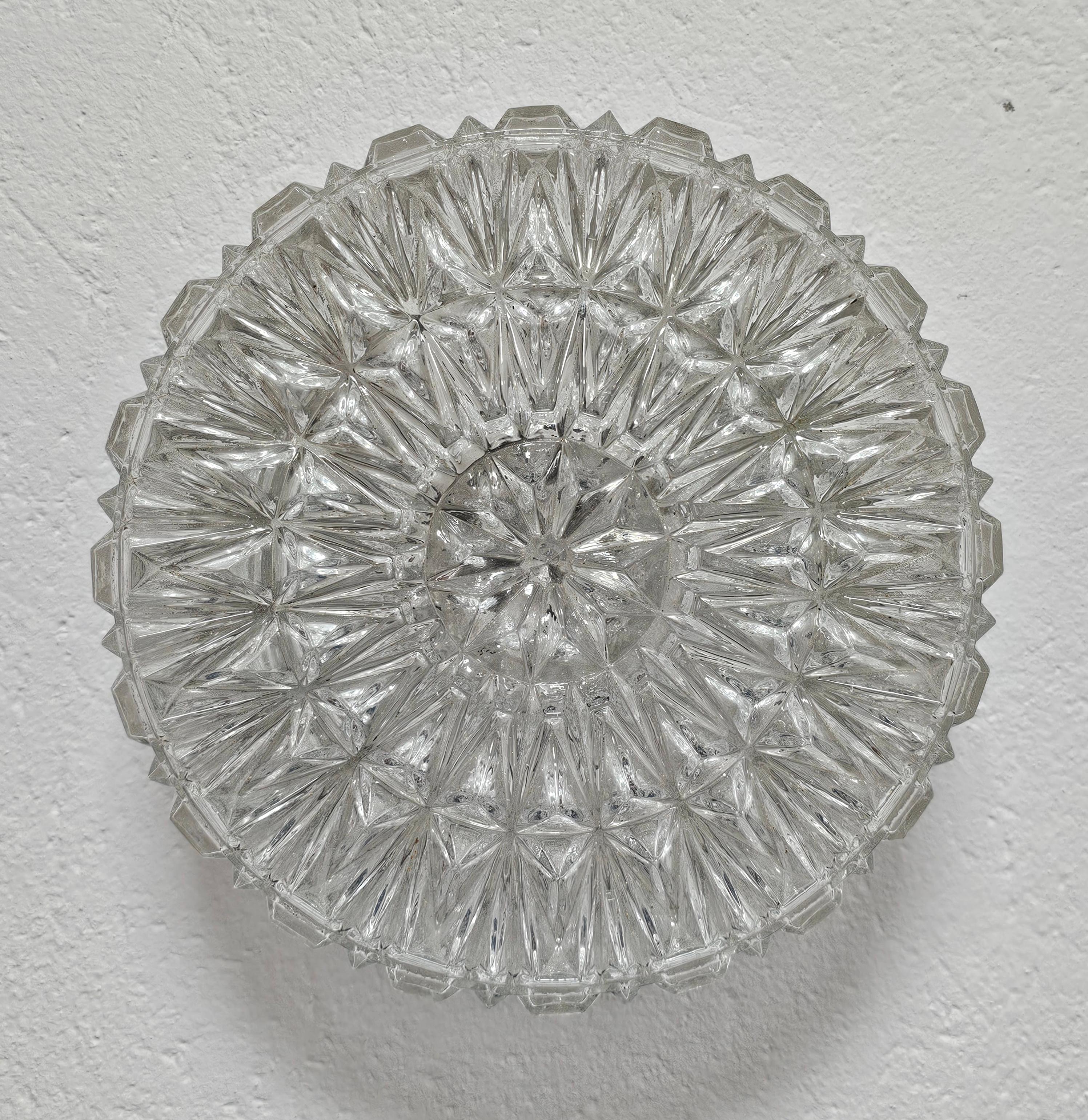 This listing presents a beautiful, large mid century modern flush mount  or sconce manufactured by ERCO. Manufacturer's label is still attached on the inside of the flush mount. It is done in thick glass with beautiful icy relief, reminding us of a