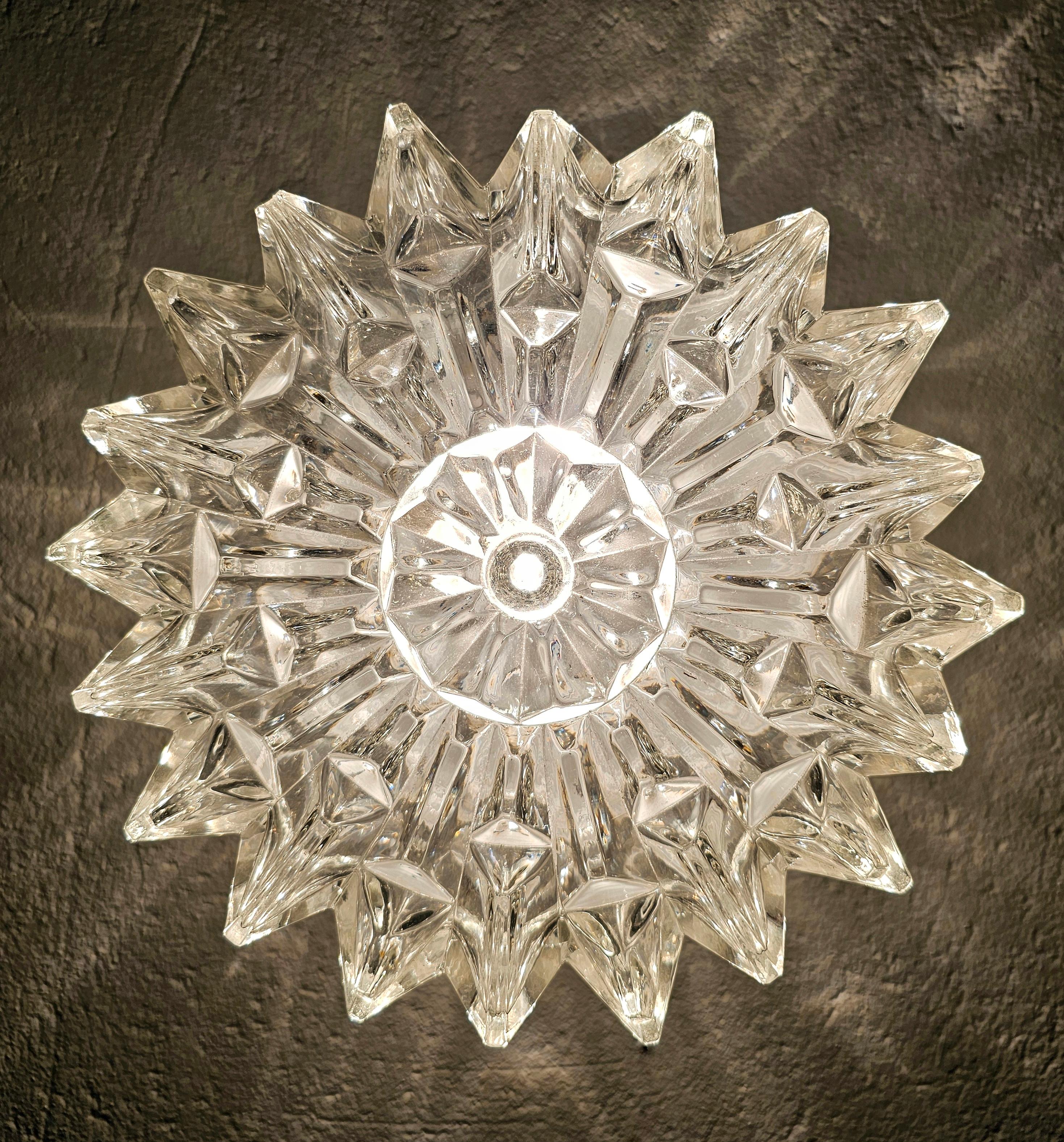 This listing presents a beautiful mid century modern flush mount or sconce shaped as a snowflake, with beautiful edges, which create very attractive light. It is done in thick glass with beautiful icy relief.. This very decorative piece of lighting