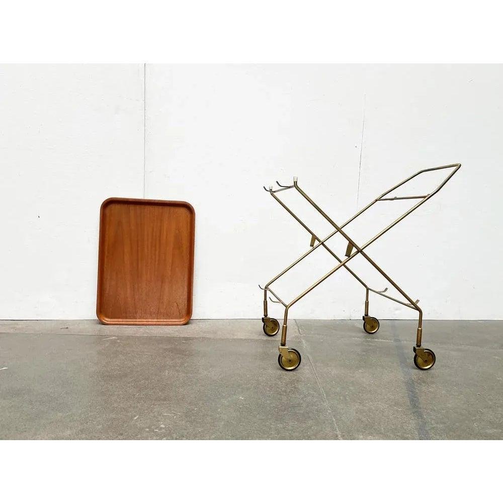 Mid-Century Foldable Teak and Metal Bar Trolley from Silva Denmark, 1960s, in Very Good conditions. Designed 1960 to 1969 This piece has an attribution mark.

Additional information:
Materials: Metal, Wood
Styles: Mid-Century Modern
Country of