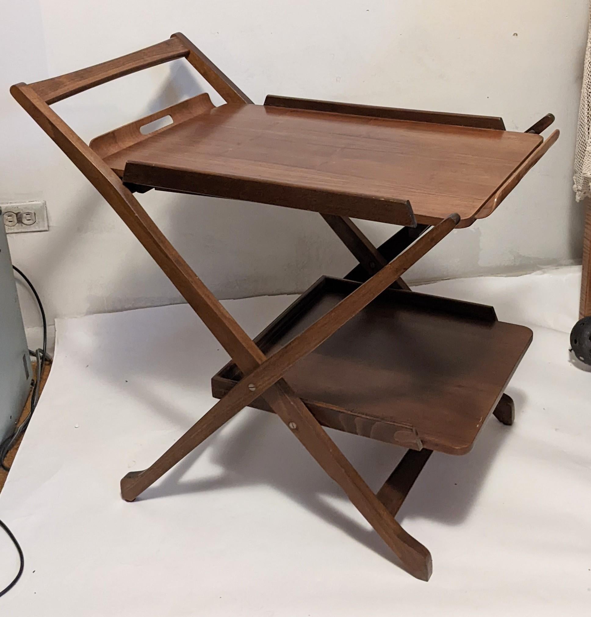 1960's folding wood bar stand with removable tray. Super practical for apt living, the cart folds flat and the removable tray even has extendable legs for use as a small side table or for use serving breakfast in bed. The pieces all fold flat for