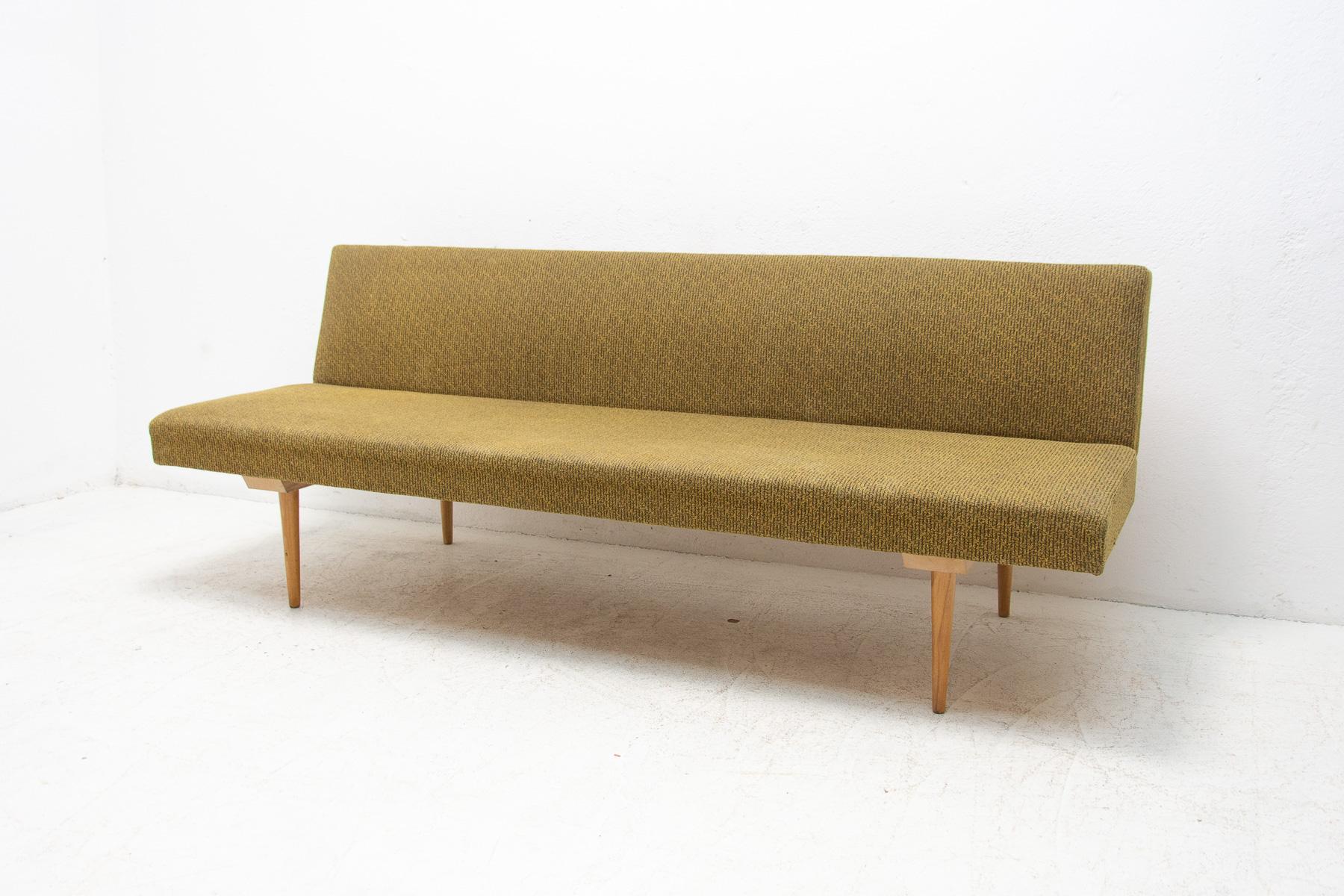 Mid century sofa/daybed, made in the former Czechoslovakia in the 1960´s, designed by Miroslav Navrátil. Material: beech wood, fabric. The sofa is structurally in good Vintage condition, the fabric bears signs of age and using.

Measures: Height: