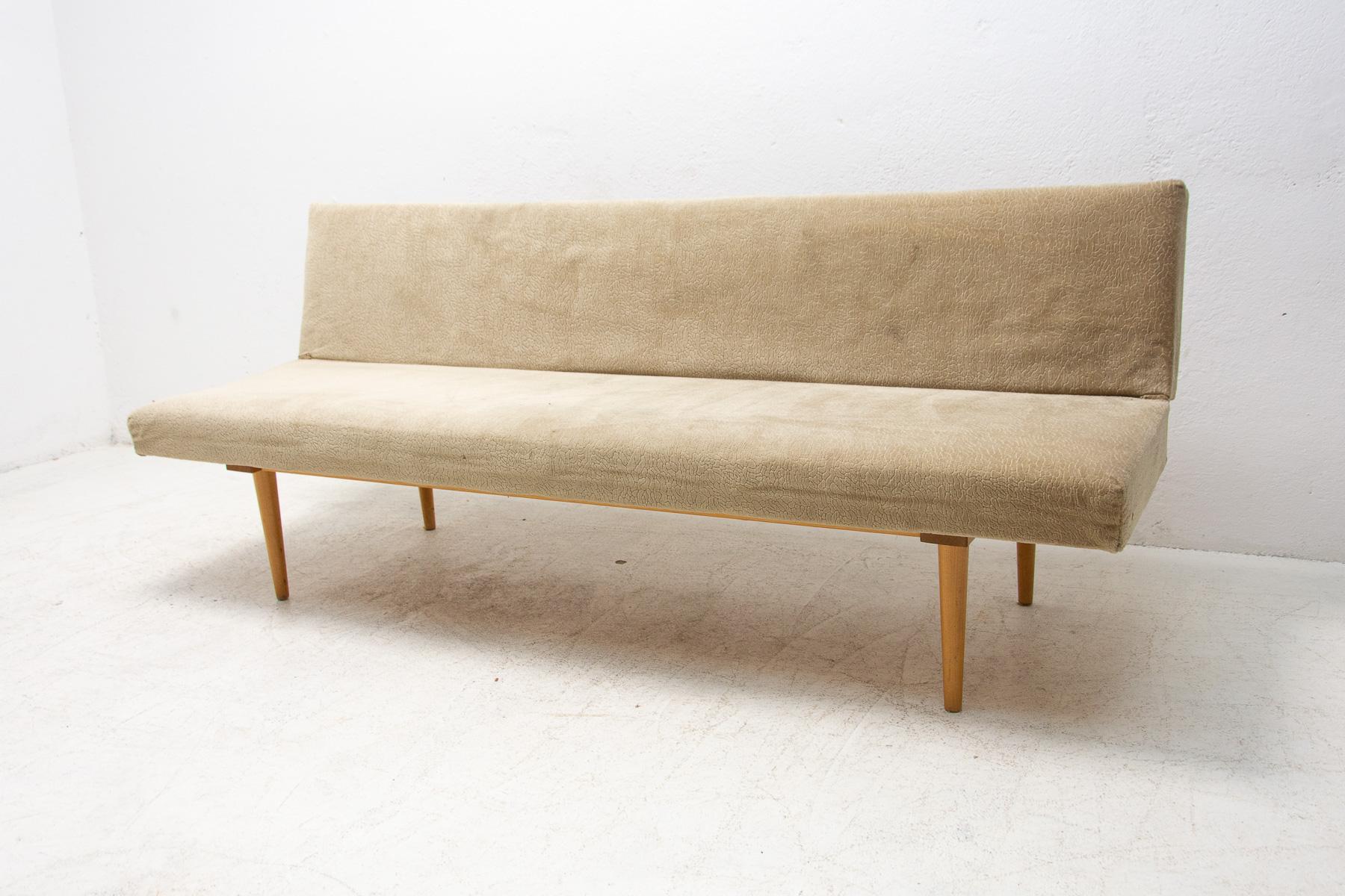 Mid century sofa/daybed, made in the former Czechoslovakia in the 1960´s, designed by Miroslav Navrátil. Material: beech wood, fabric. The sofa is structurally in good Vintage condition, the fabric bears signs of age and using.

Measures: Height:
