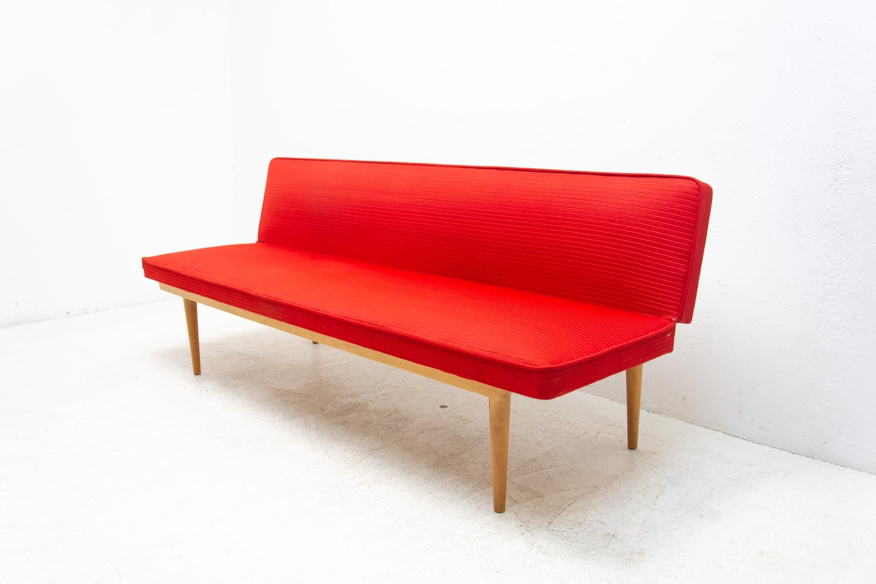 Mid century sofa/daybed, made in the former Czechoslovakia in the 1960´s, designed by Miroslav Navrátil. Material: beech wood, fabric. The sofa is in very good Vintage condition, the fabric has been sewn in one place in the past, but it´s almost