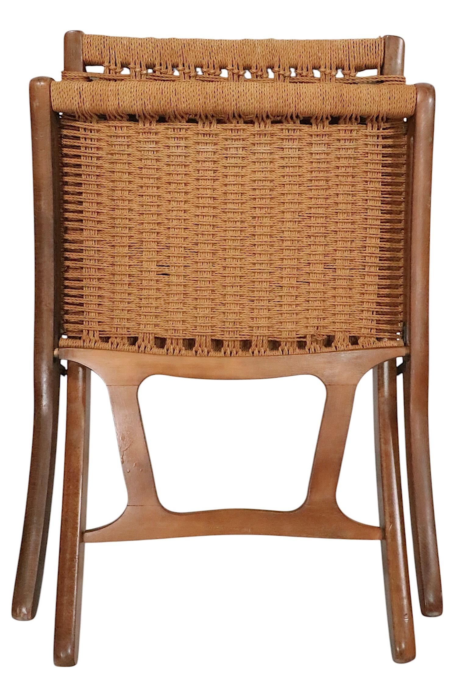 Classic mid century folding lounge chair, made in Yugoslavia, after the iconic Wegner design. The chair features a solid wood frame, with a woven cord backrest and seat. This example is in very fine, original, clean and ready to use condition,