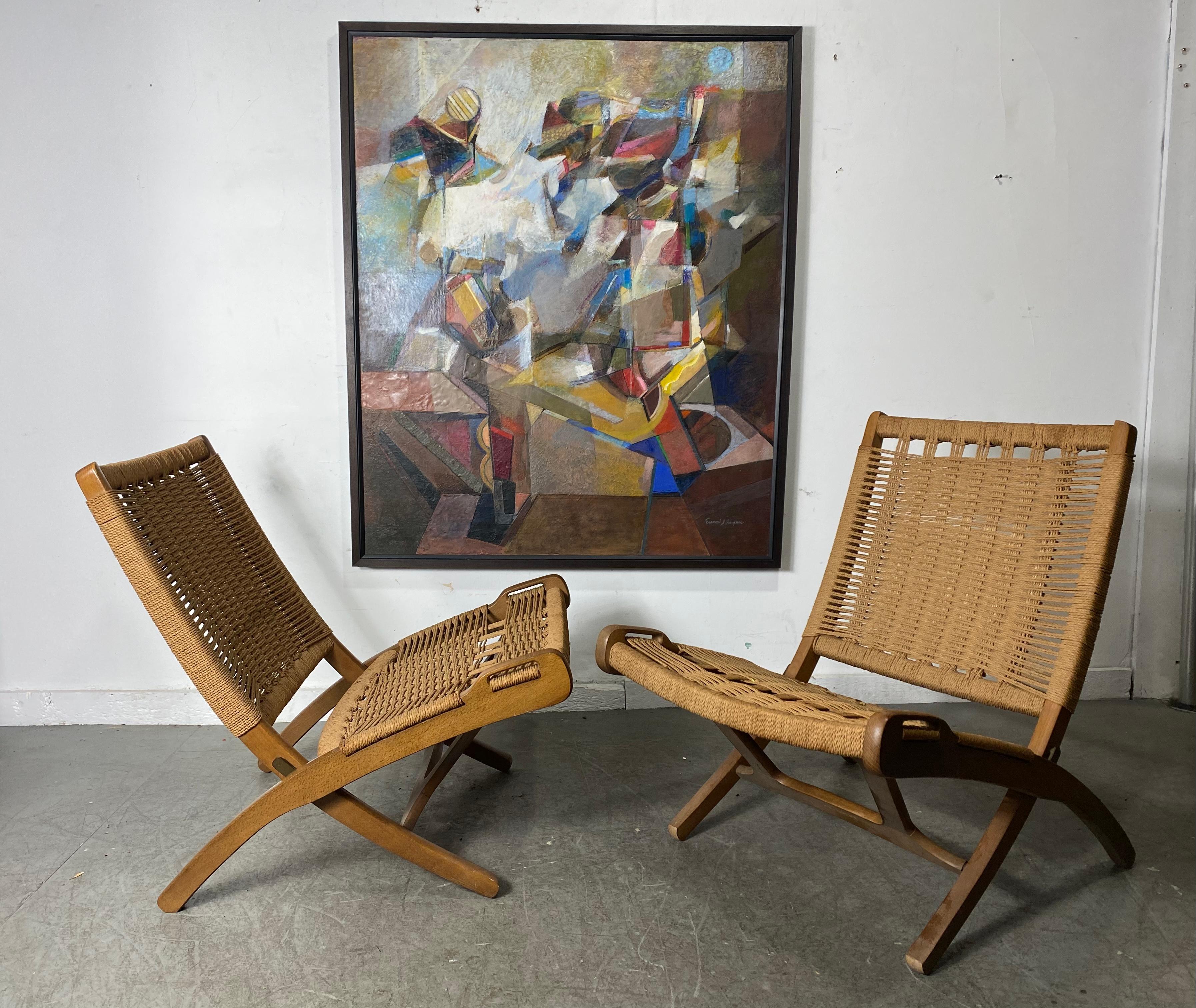 Design closely based on Hans Wegner's famous chair design.Extremely comfortable. This stunning pair of Mid-Century Modern rope chairs looks just like Wegner's iconic chairs, and they were made in Yugoslavia during the 1950s. The chairs boast