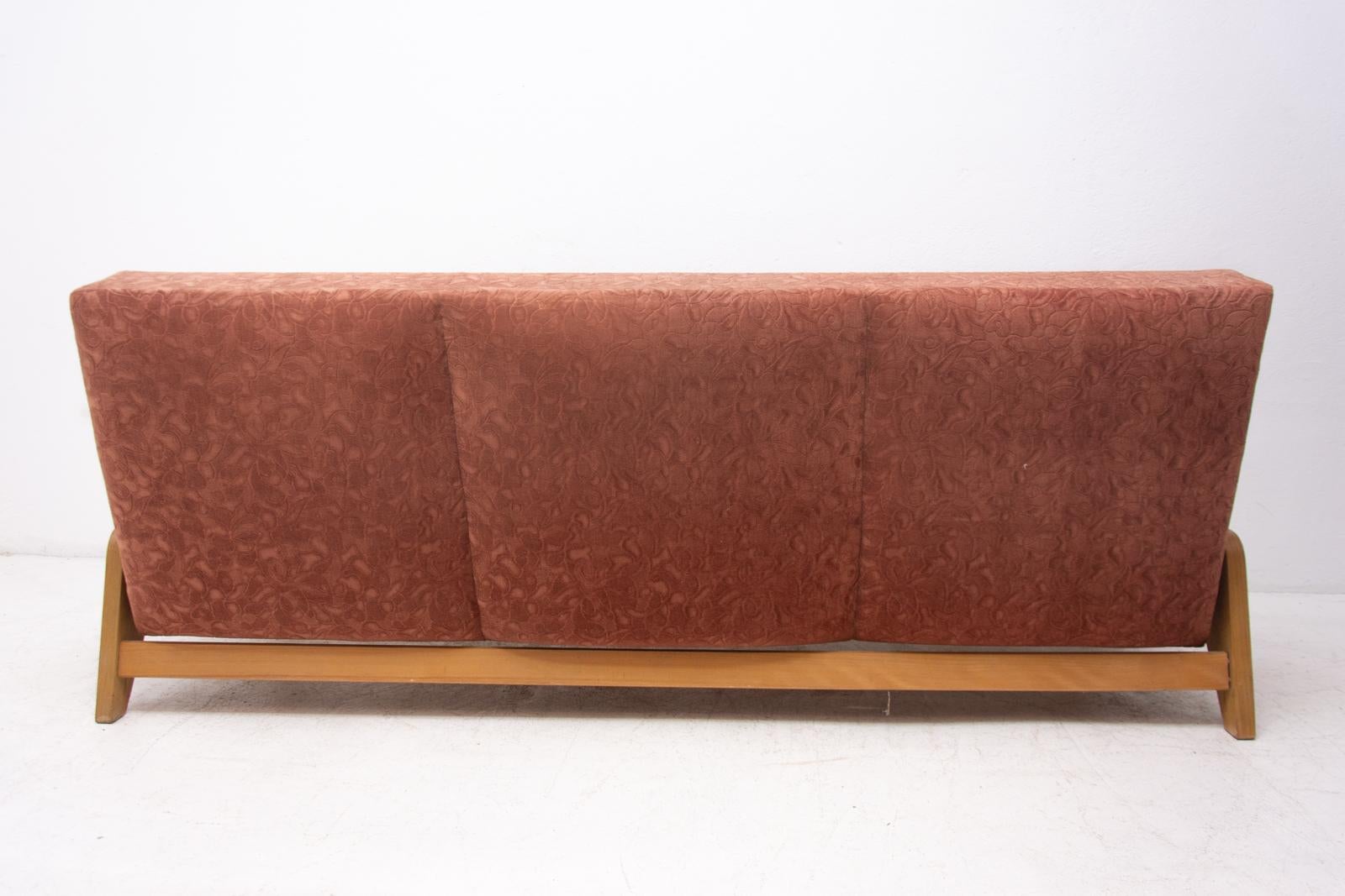 Midcentury folding sofa-bench made in the former Czechoslovakia in the 1960s. It features very attractive and simple design.

Material: Fabric, beechwood. The wooden structure and upholstery are in very good Vintage condition.

Unfolded: 120 x