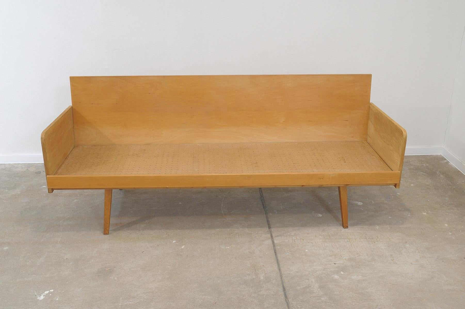 Mid century sofabed from Interiér Praha. It was made in the former Czechoslovakia in the 1960´s. This sofa has a wooden structure that is veneered in beech wood. The mattresses are rather soft but comfortable. The sofa is in very good Vintage