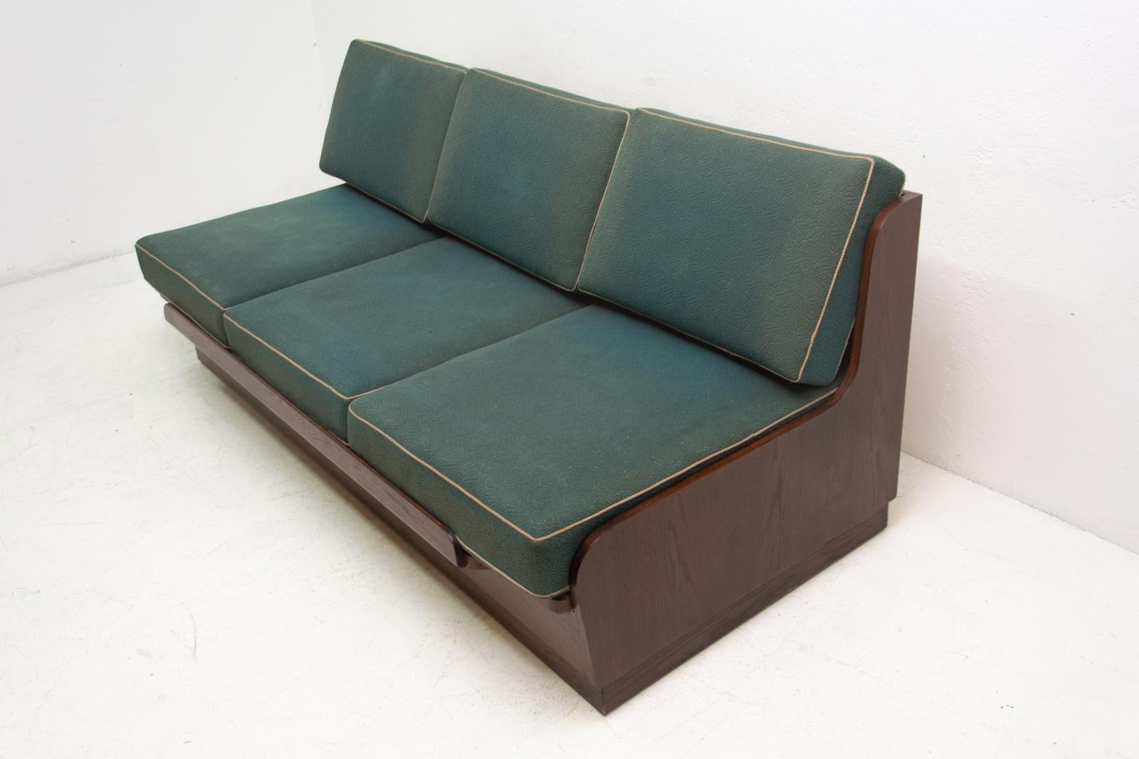 Midcentury sofa bed, it was made by Interiér Praha company in the former Czechoslovakia in the 1950s. This sofa has a wooden structure, it´s is in good Vintage condition, the mattresses are faded in places, but overall in good condition.

Measure: