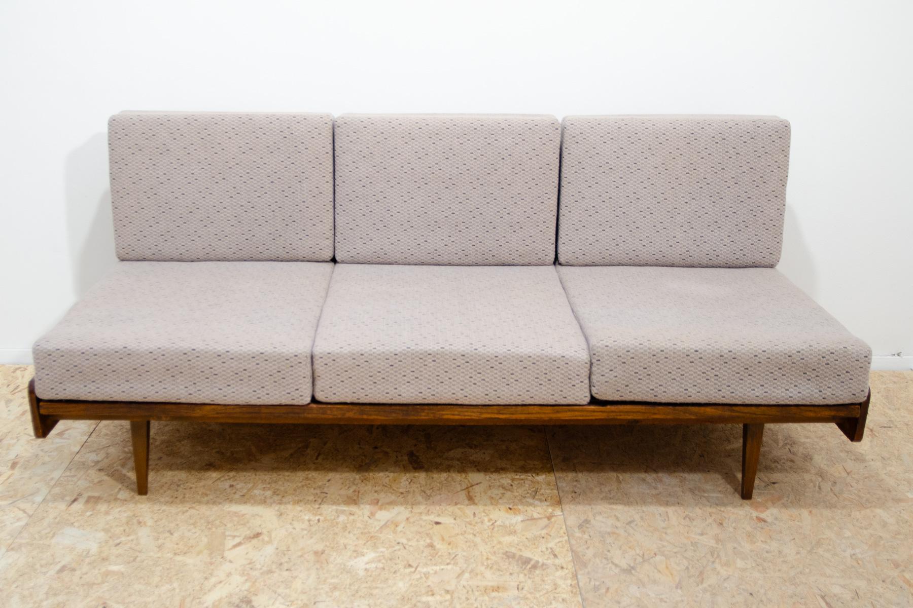 This mid century couch/sofabed was made by Interiér Praha company in the former Czechoslovakia in the 1960´s. The sofa has a pull-out mechanism which you can easily use to fold the sofa into a bed.Material: beech wood, fabric. The sofa is in good