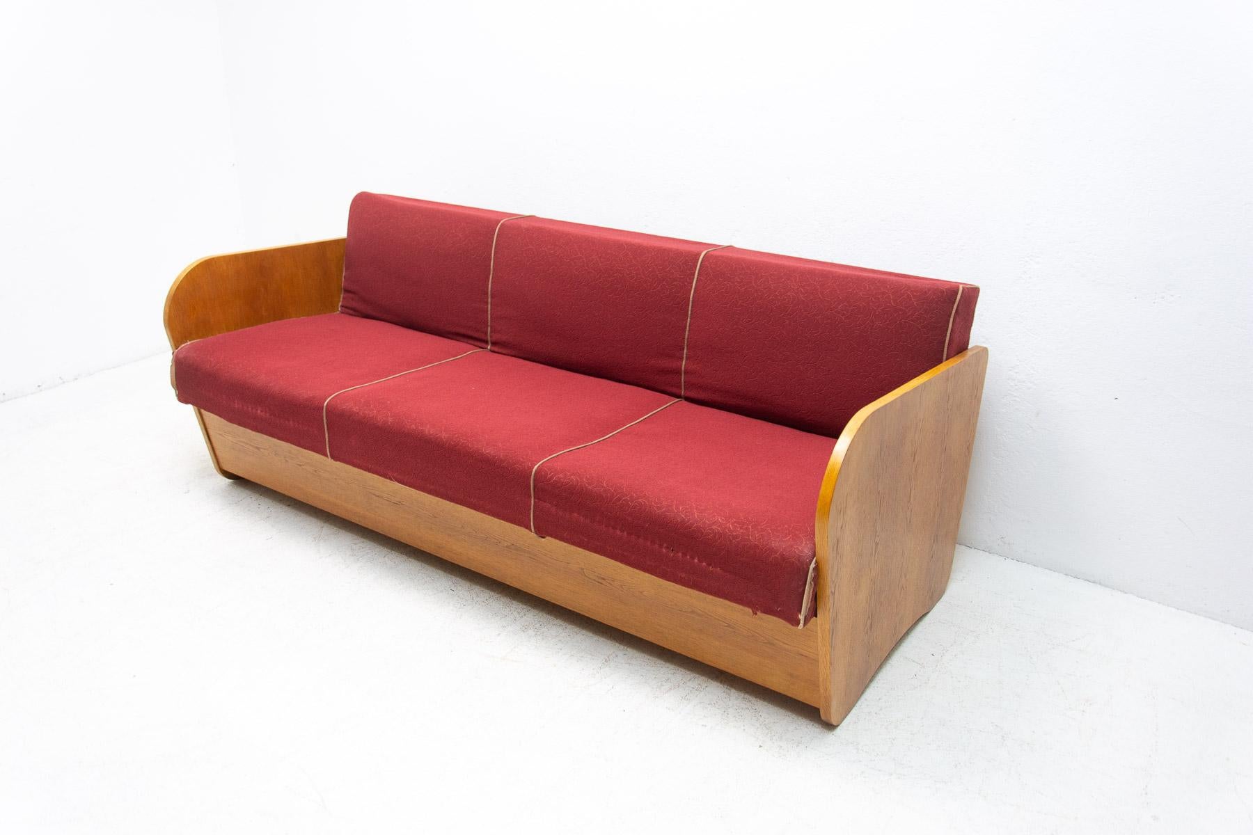 This folding sofabed with storage space was designed by the famous Czechoslovak architect Jindrich Halabala in the 1950´s. Very attractive and simple design. The construction is of beech wood. Overall in good Vintage condition, showing signs of age