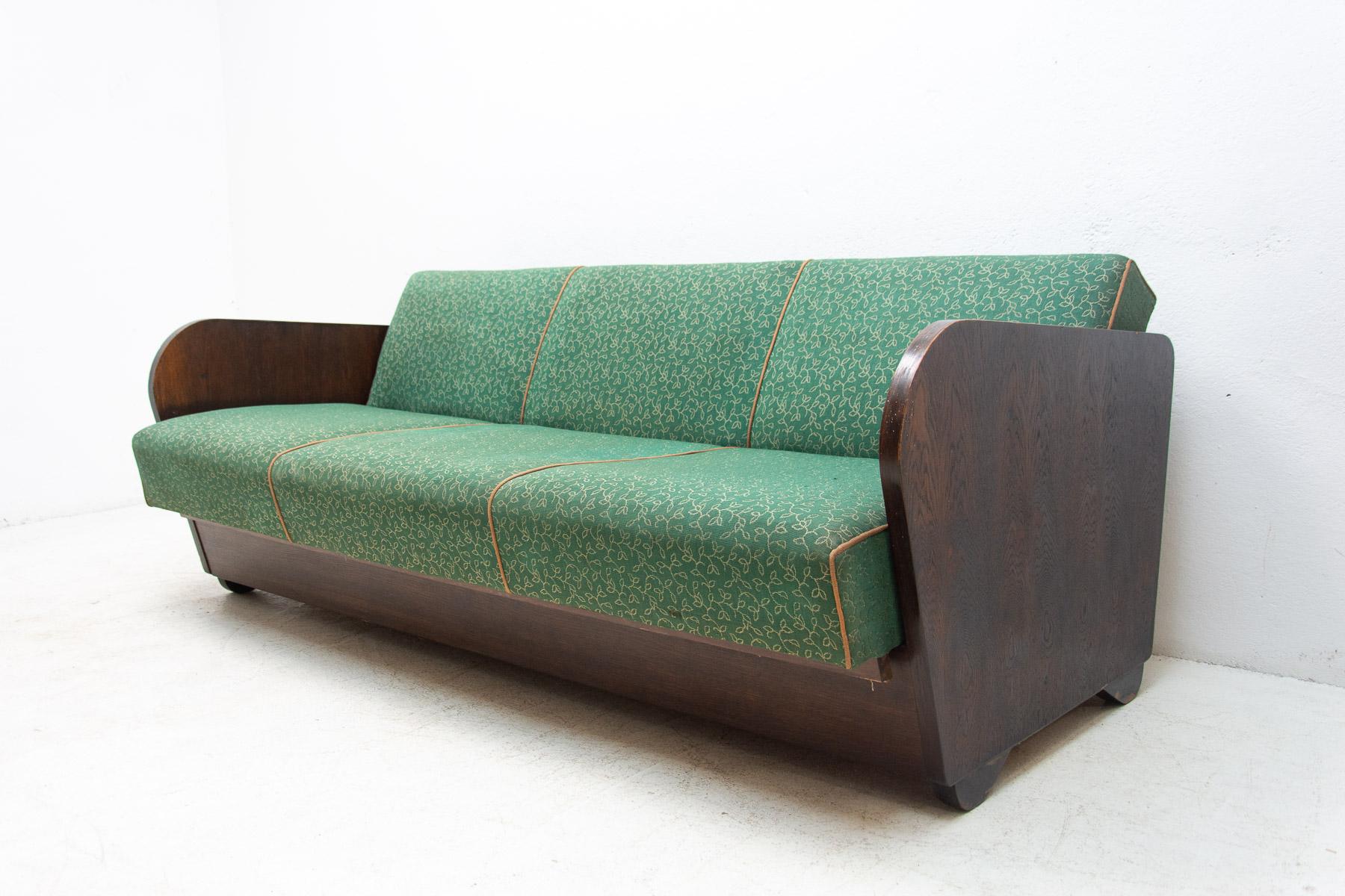 This folding sofabed with storage space was designed by the famous Czechoslovak architect Jindřich Halabala in the 1950´s. Very attractive and simple design. The construction is of beech wood. Overall in good Vintage condition, showing signs of age