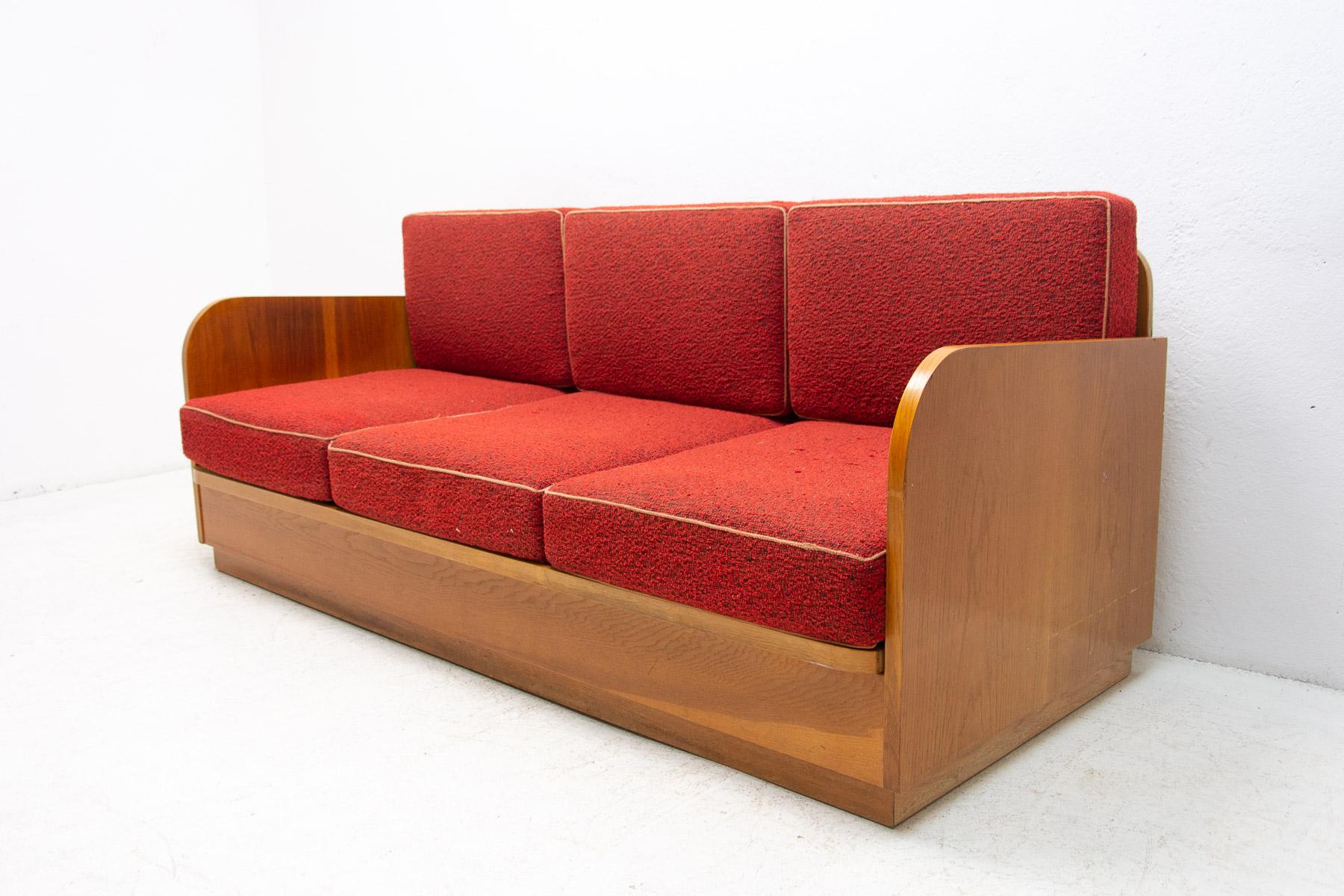 This folding sofa was made by Jitona company in 1959. Very attractive and simple design. The construction is of solid wood with beech wood veneer. Overall in good Vintage condition, showing signs of age and using.

Measures: Length: 196 cm, height