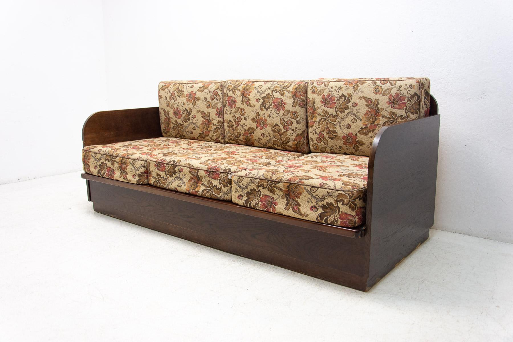 This folding sofabed was made in the former Czechoslovakia in the 1950´s. The construction is of wood and it´s veneered with dark stained beech wood.

Overall in good Vintage condition, showing signs of age and using(a few small scuffs on the