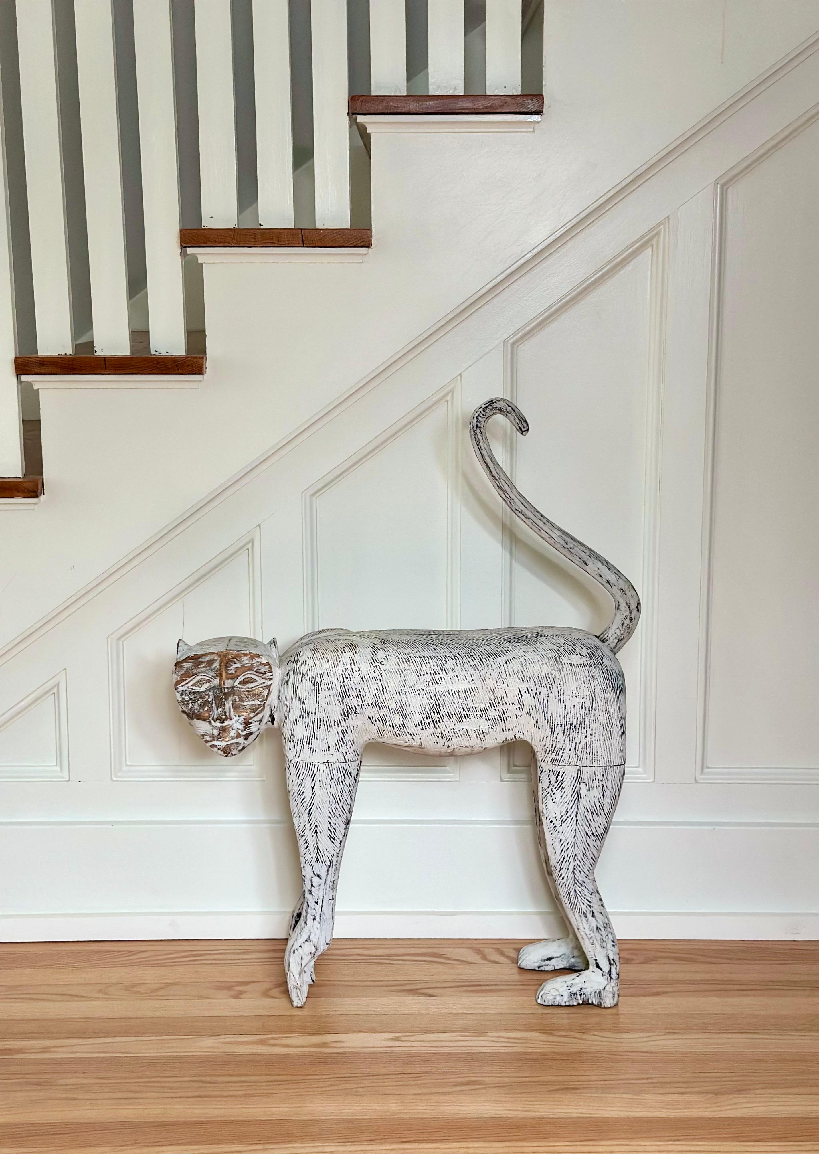 We are very pleased to offer a carved wooden monkey sculpture, this piece brings together folk tradition and sculptural artistry in a strikingly playful form. Hand-carved with elongated proportions and a high curling tail (can be adjusted to a lower