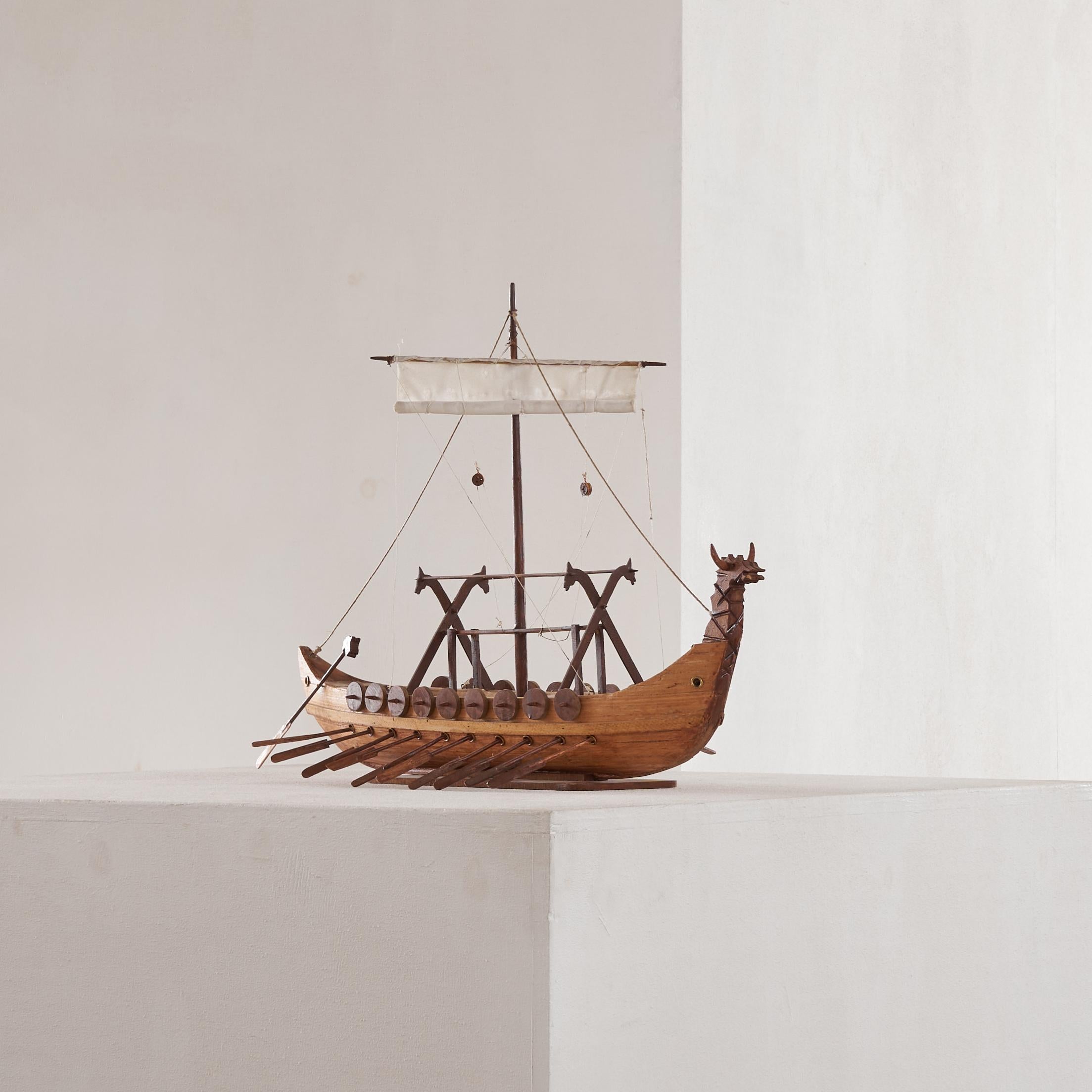 Mid Century Folk Art Viking Ship in Wood 1960s.

Beautiful folk art viking ship, made by a craftsman at home or maybe as a school project somewhere around the 1960s or 1970s. Wonderfully detailed, but naive and rough at the same time - this viking