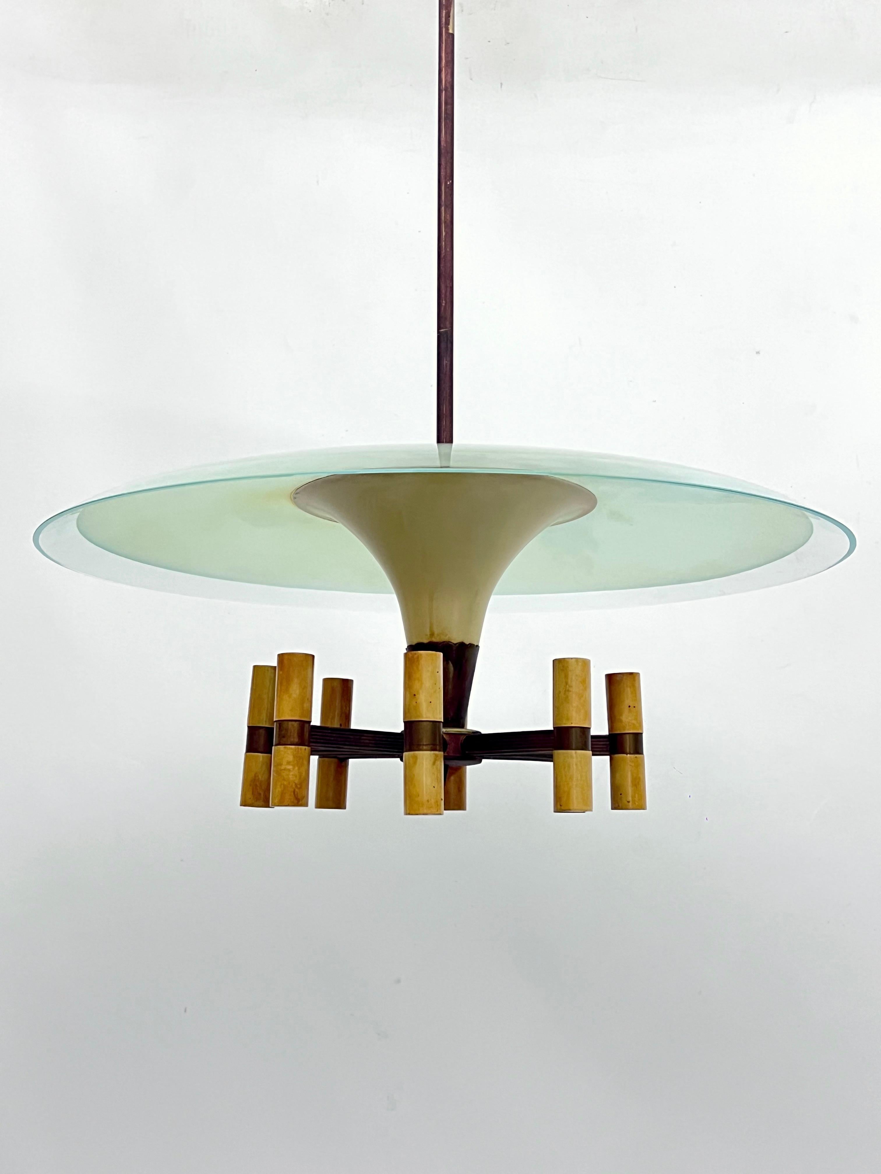 Rare disk chandelier with 8 arms in Fontana Arte  manner produced in Italy during the 50s. Made from brass and laquer with original patina and curved glass. Fair vintage condition with trace of age and use. Some loss of lacquer and oxidation on the