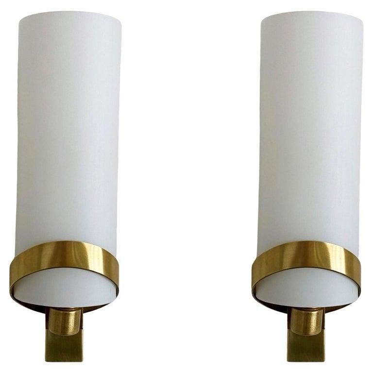 A pair of Fontana Arte wall sconces, Italy, 1950, modernist and clear lines design with satin glass shades supported by elegant brass mounts. Both sconces in fine vintage condition. 
It takes one candlabra E14 light bulb each.
Dimentions: height