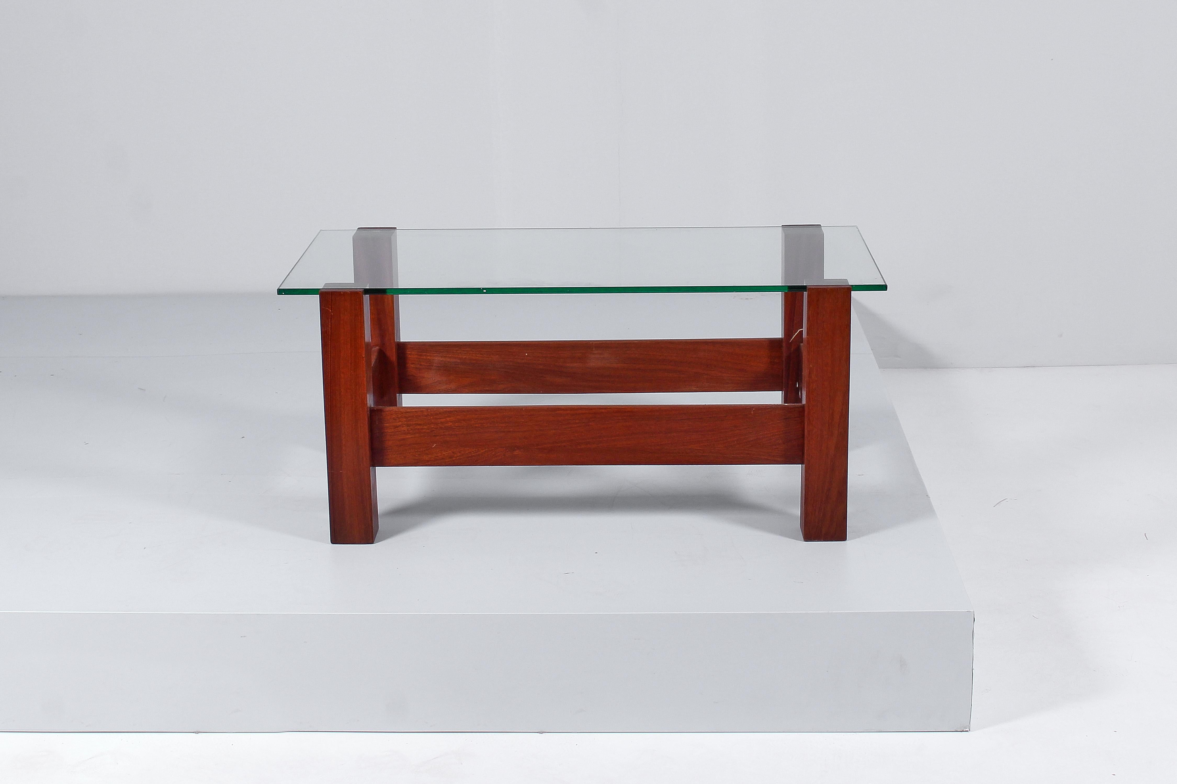 Coffee table with a geometric design, with wooden structure and rectangular glass top. In the style of Fontana Arte, Italian production from the 60s.
Wear consistent with age and use.