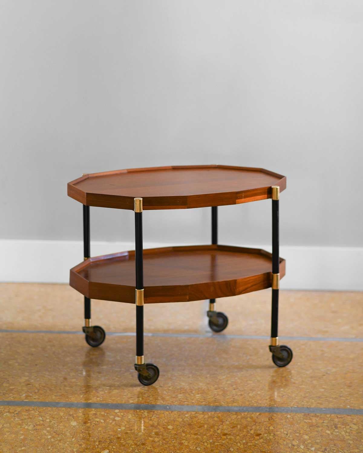 MID-CENTURY FOOD HOLDER BAR TROLLEY WITH REMOVABLE TRAY
Bar trolley with removable tray and wheels, made of wood, metal
and brass details.
PRODUCT DETAILS
Dimensions of stacked tables: 76w x 64h x 49d cm
Materials: wood, brass,