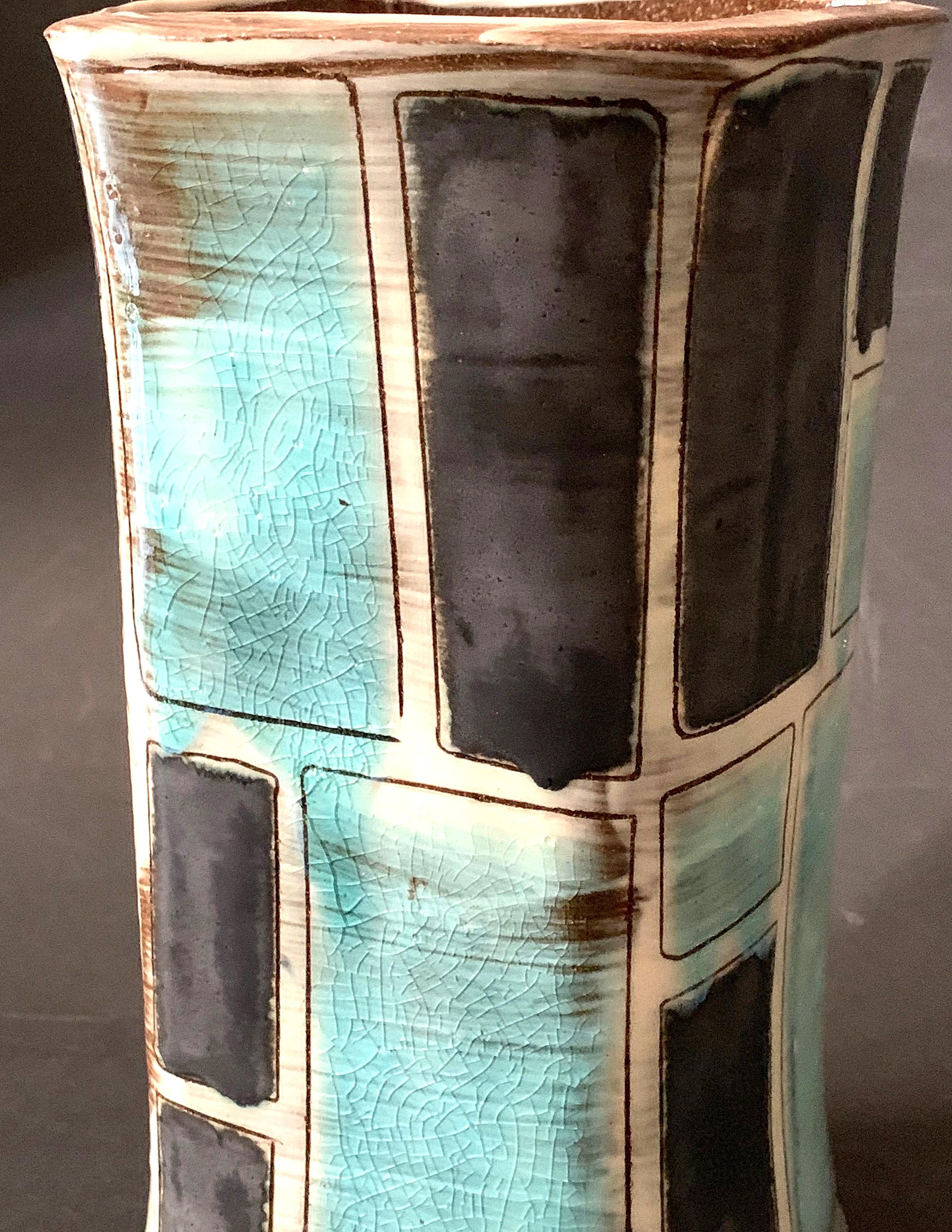 Substantial and beautifully glazed, this midcentury vase is decorated with a series of black and aqua panels on a white ground. Clearly influenced by the glass and pottery produced in Italy after World War II, the vase's color palette and decorative