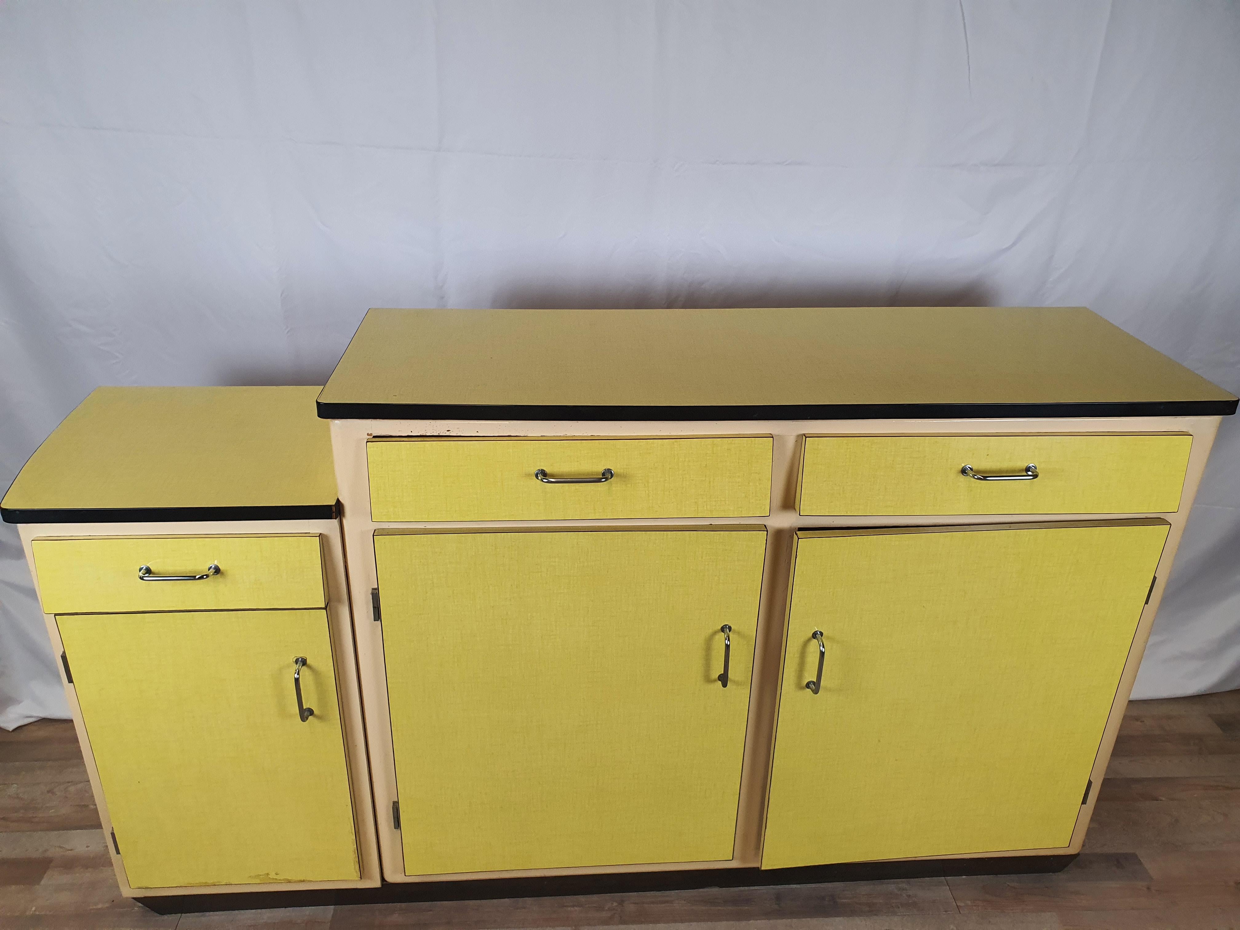 Modern sideboard in formica with fir interiors, ideal for kitchens or vintage and antique dining room furniture.

Particular for the white and yellow color which give contrast to the piece of furniture and make it a beautiful scenographic design