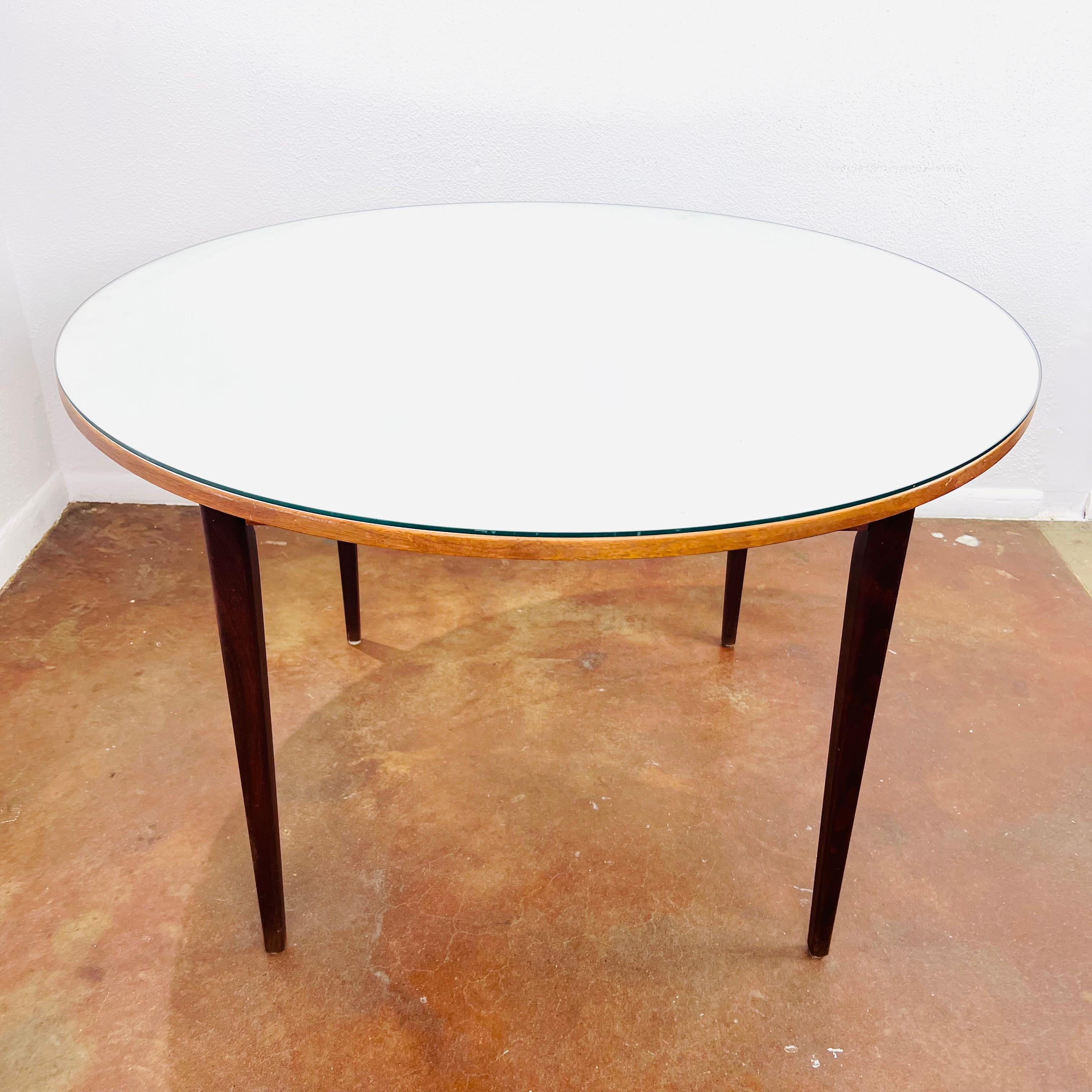 Vintage round dining table with white formica and round glass top. Great compact size for any dining or kitchen space. Some dings/scratches/wear on wood due to normal age and use. Good structrual condition.