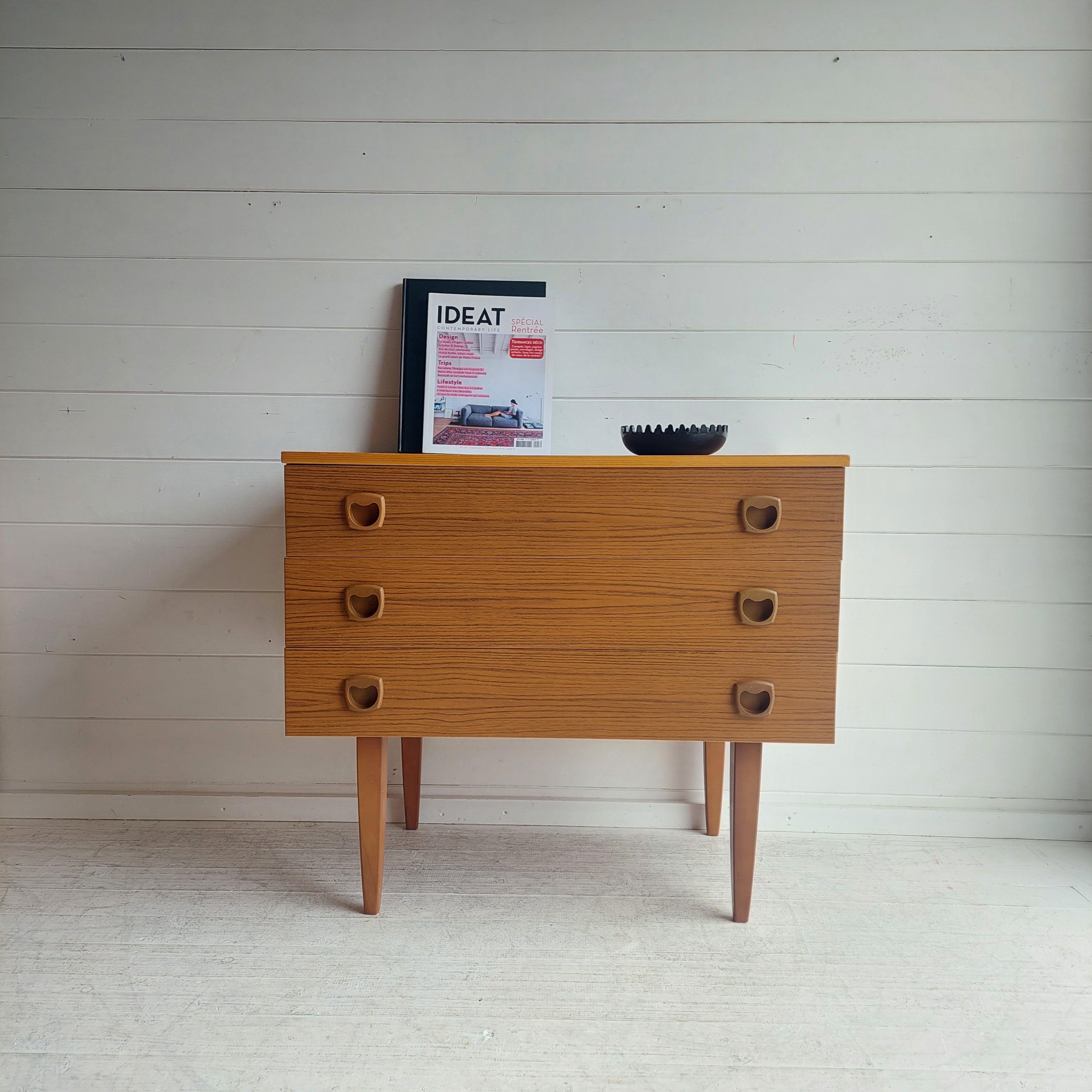 A retro teak three drawer chest of drawers / side table / bedside cabinet 
Mid century chest for any styled home
Made most probably in England by Europa Furniture or Schreiber, dating from around the 1960-70's

Finished in Formica teak effect veneer