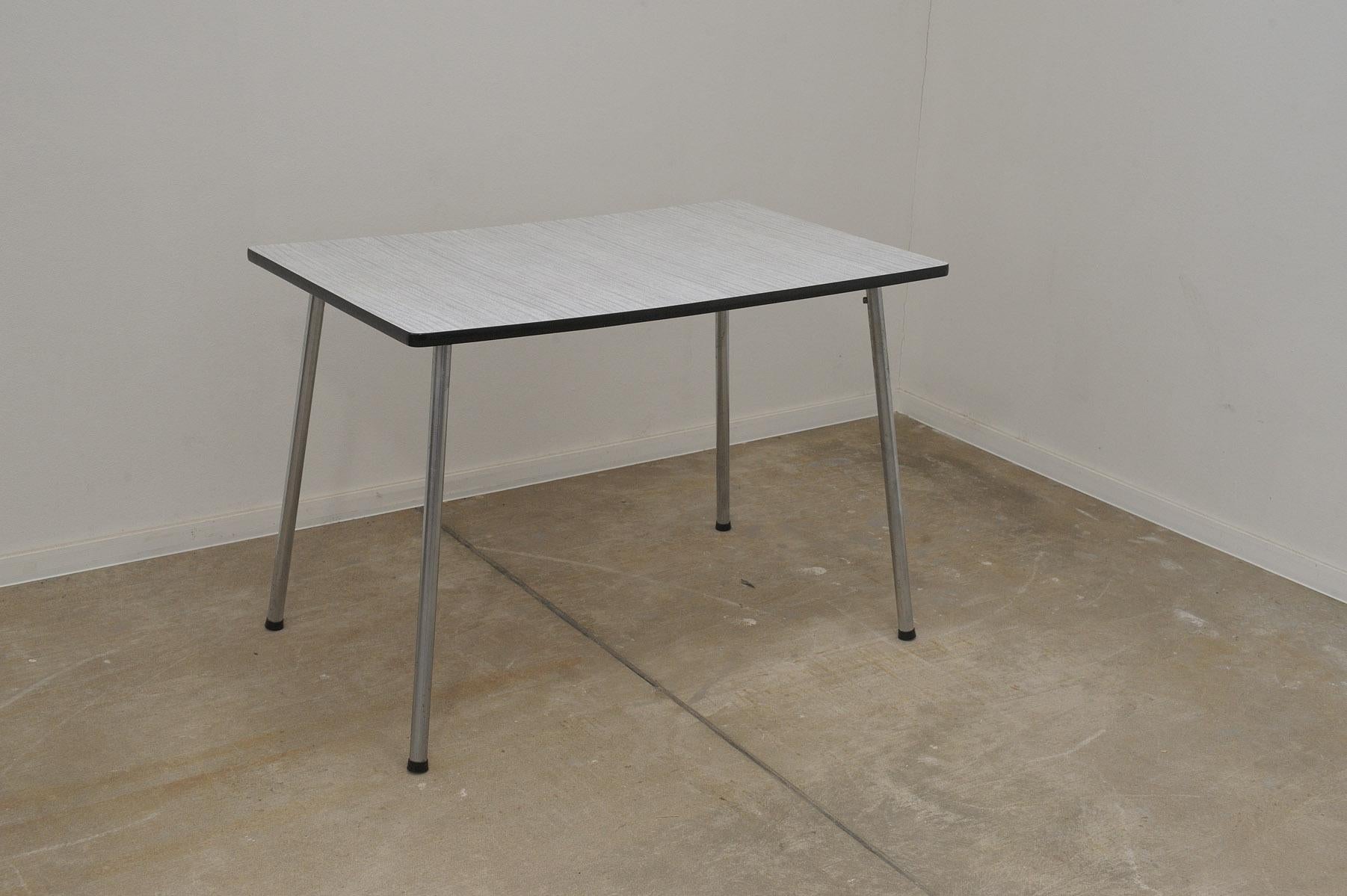 Mid century writing desk or side table, it features a formica surface and chromed legs and one drawer. It was made in Czechoslovakia in the 1960´s.

the table top is lined with a black plastic strip.

The table is in original functioning condition,
