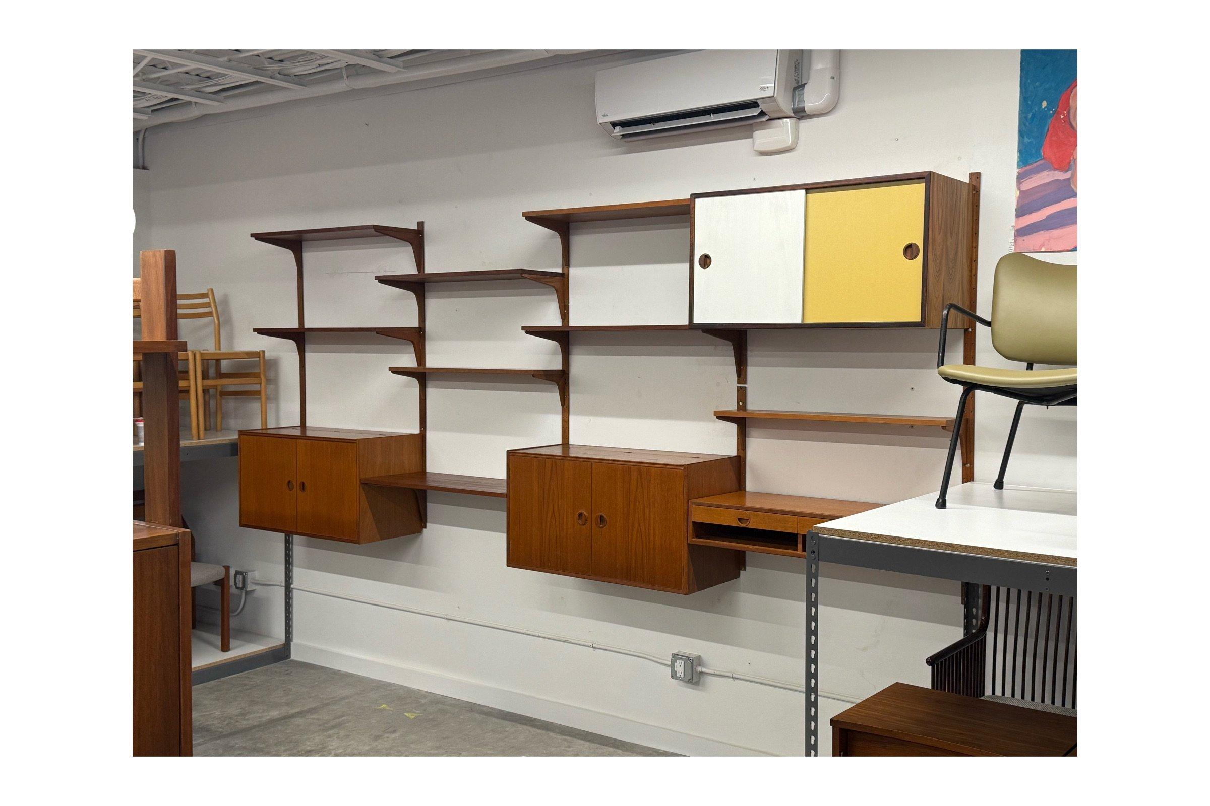Mid-century modular wall unit designed by Hansen and Guldborg, Denmark. Expertly crafted from high-quality teak wood this modular unit is both a statement of style and a practical storage solution. Its clean lines, geometric shapes, and thoughtful