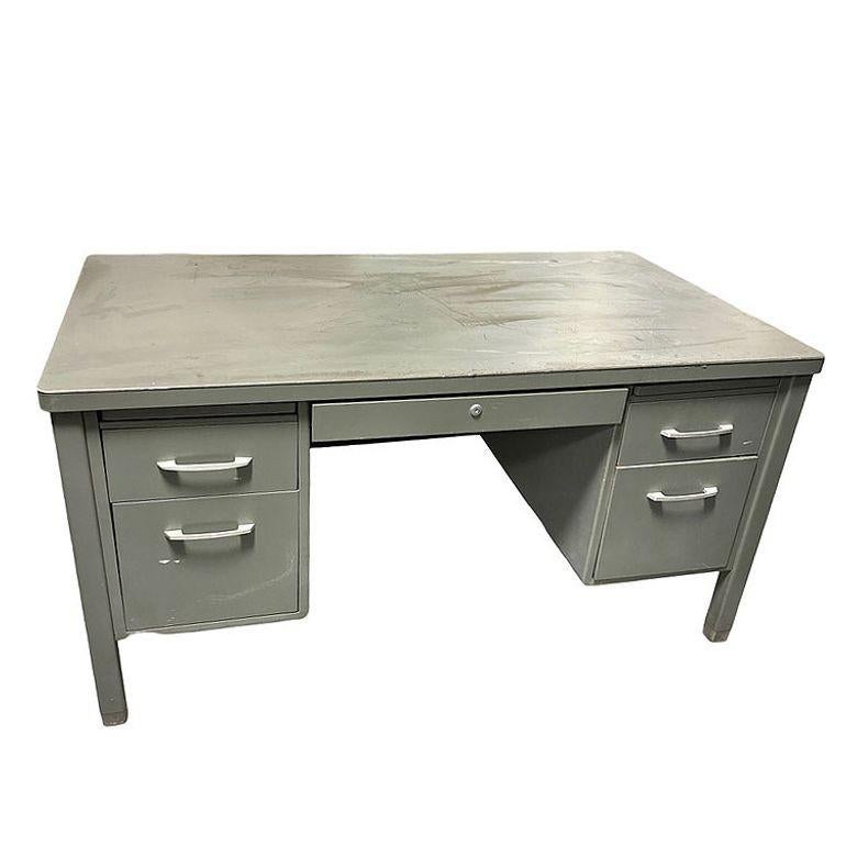 A 1950s powder-coated steel case tanker desk with four drawers by the General Fireproofing Company with a Velvoleum top. Tanker desks from this era are known for their heavy steel construction and grey enamel finish. Their industrial look works well